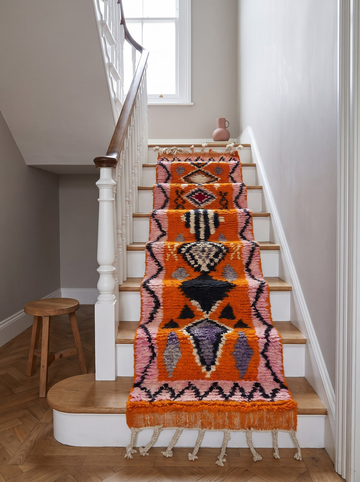Khamlia Berber stair runner, Boujad style, in orange and pink, on a staircase, hand-knotted in Morocco