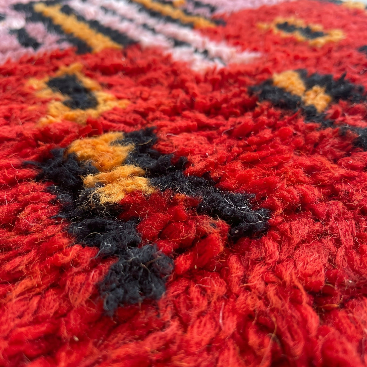 Close-up of a motif on the Imilchil Berber stair runner, long pile in pink and red tones