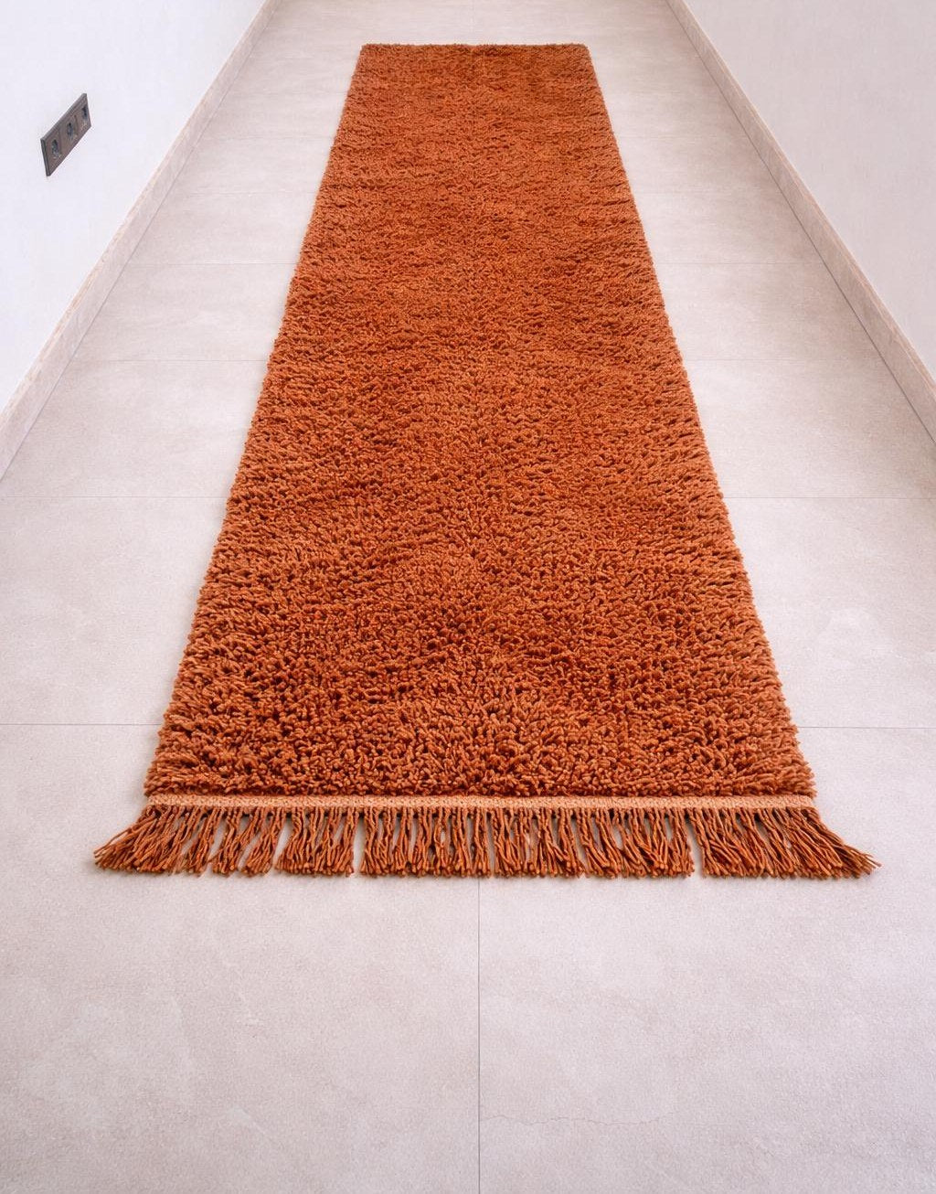 Guercif plain terracotta Berber stair runner on the floor, seen from the side, hand-knotted in Morocco