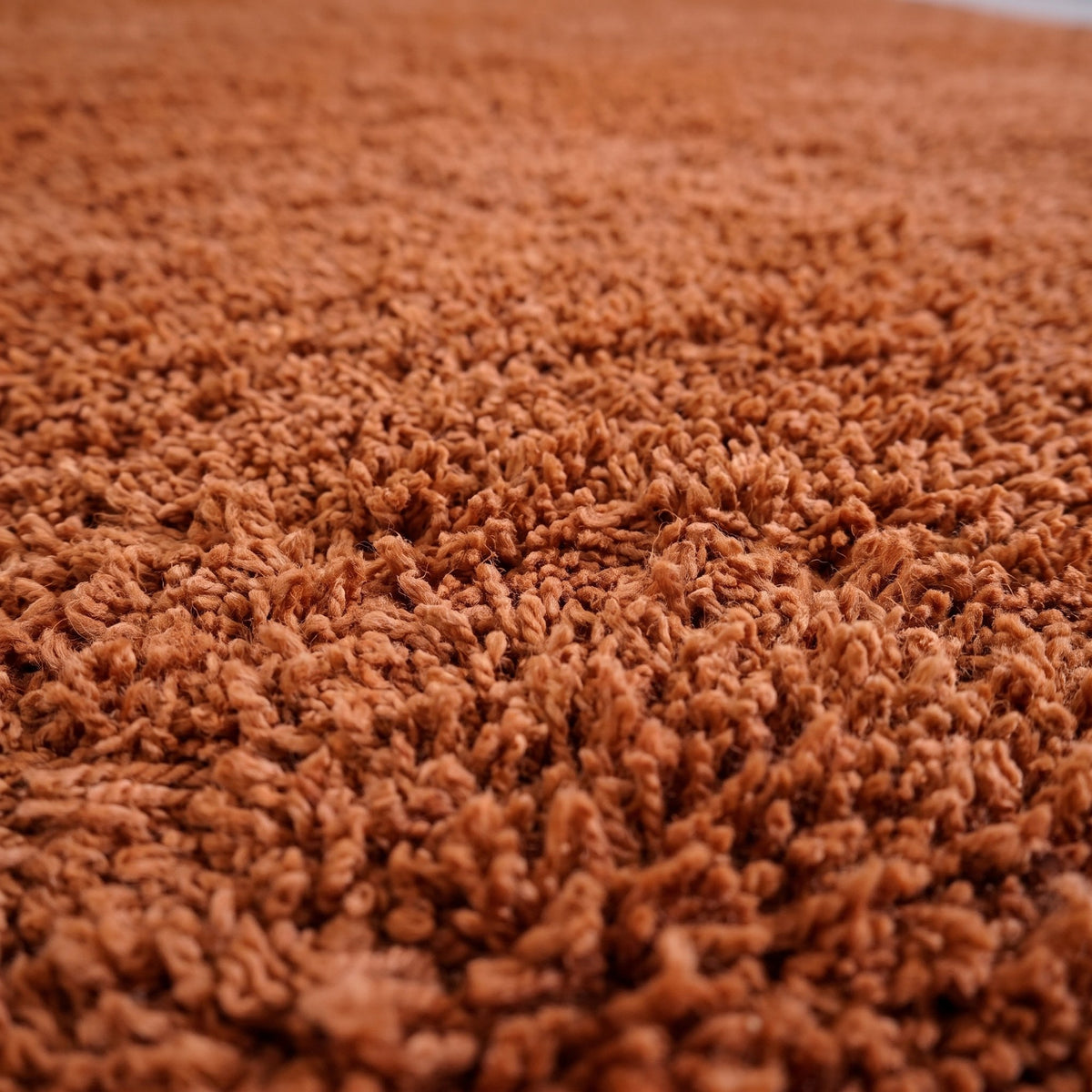 Close-up of a motif on the Guercif Berber stair runner, plain cognac brown runner with dense medium pile