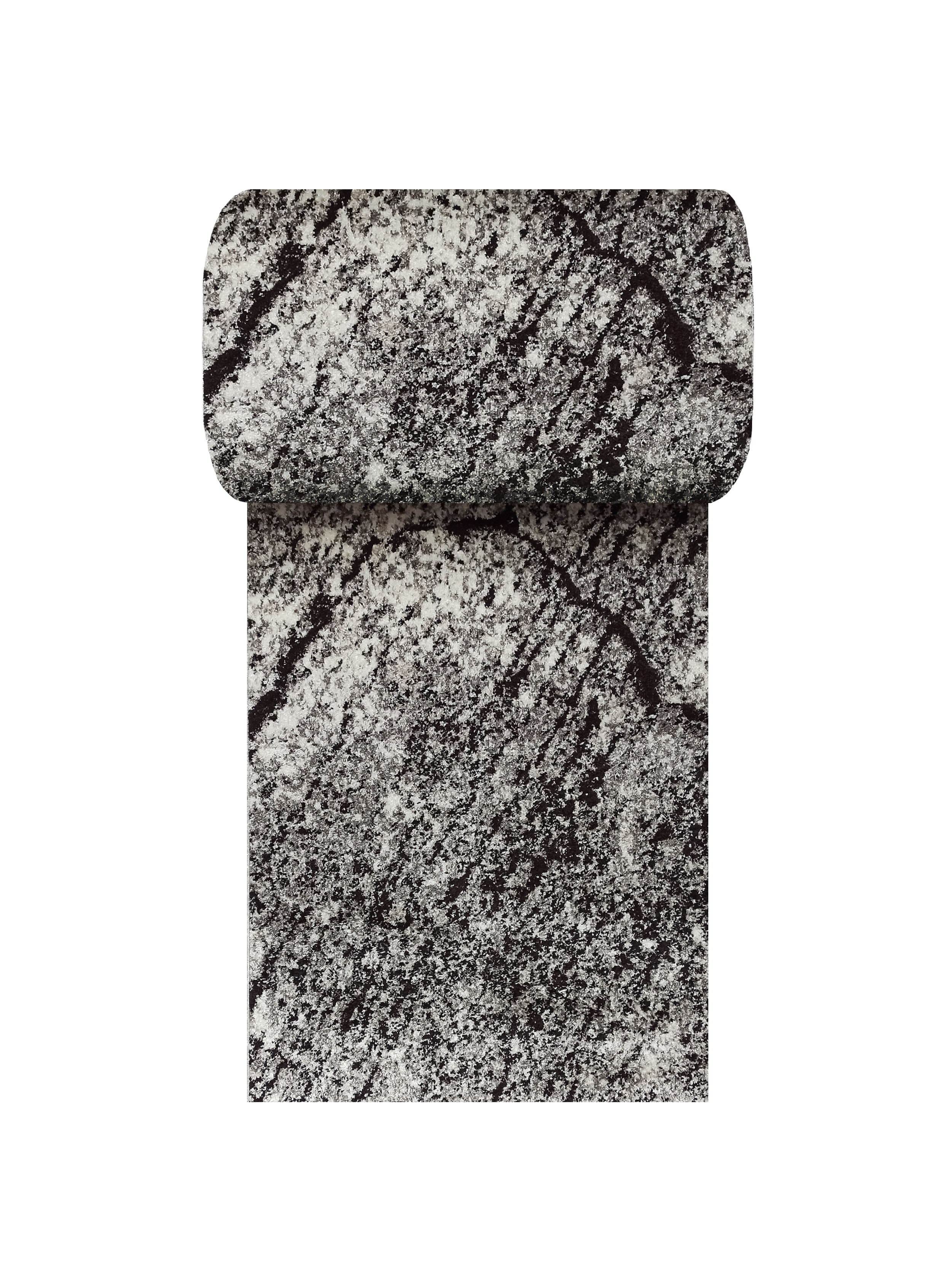 Tapis noir et blanc aux motifs abstraits mouchetés de fibres mélangées, un coin supérieur est roulé, sa texture est douce