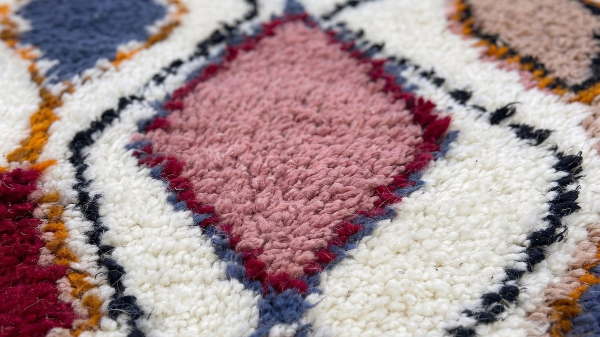Gros plan sur la laine du tapis de couloir berbère Anaruz, poil blanc multicolore noué à la main