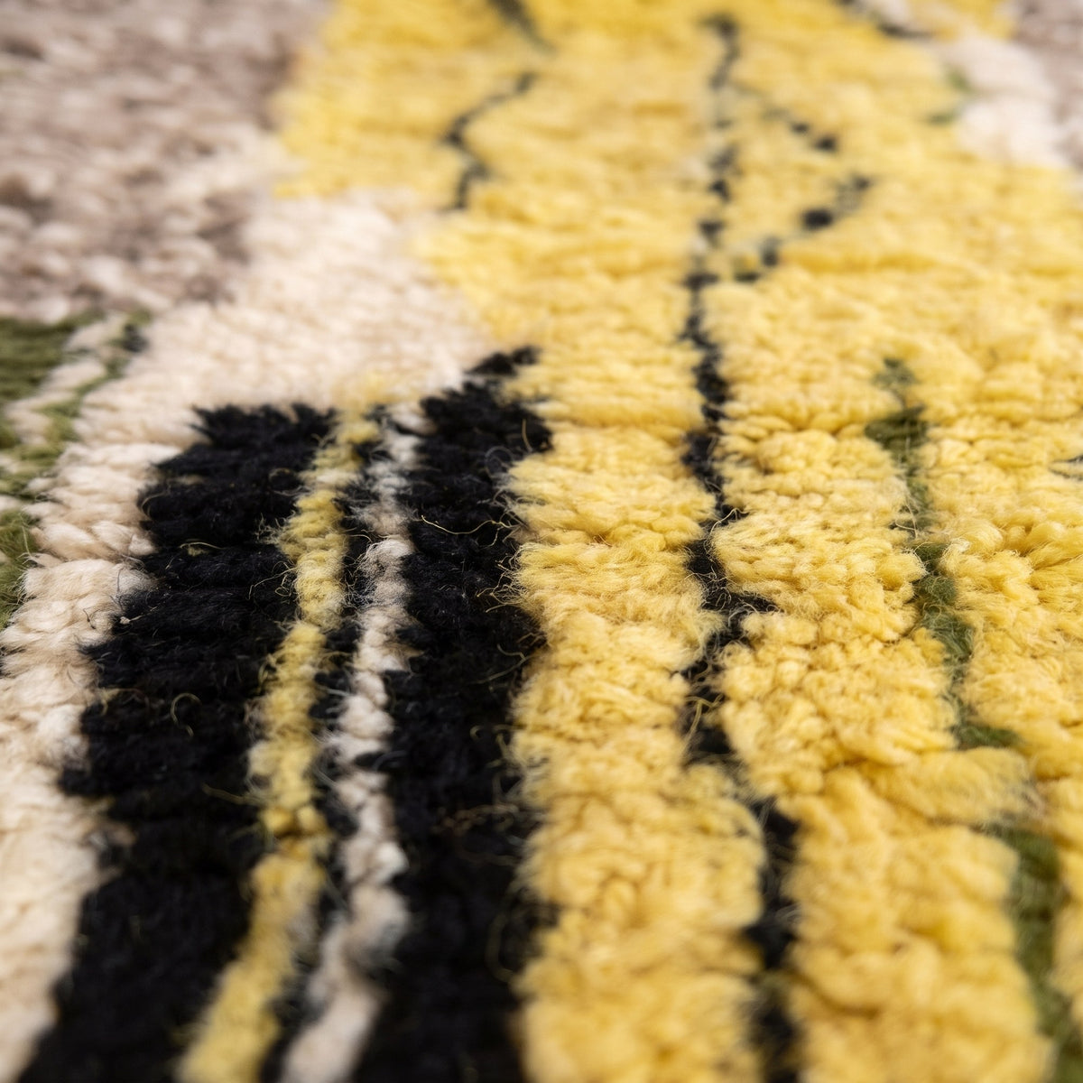 Gros plan sur un motif du tapis de couloir berbère Iznagal, couloir, bande noire en haut, bloc bleu strié