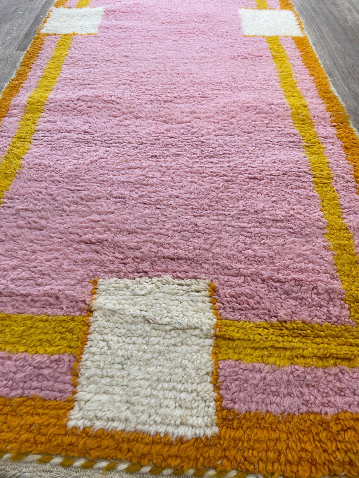 Close-up of a detail on the Berkane Berber runner, long pile and pattern in pink up close