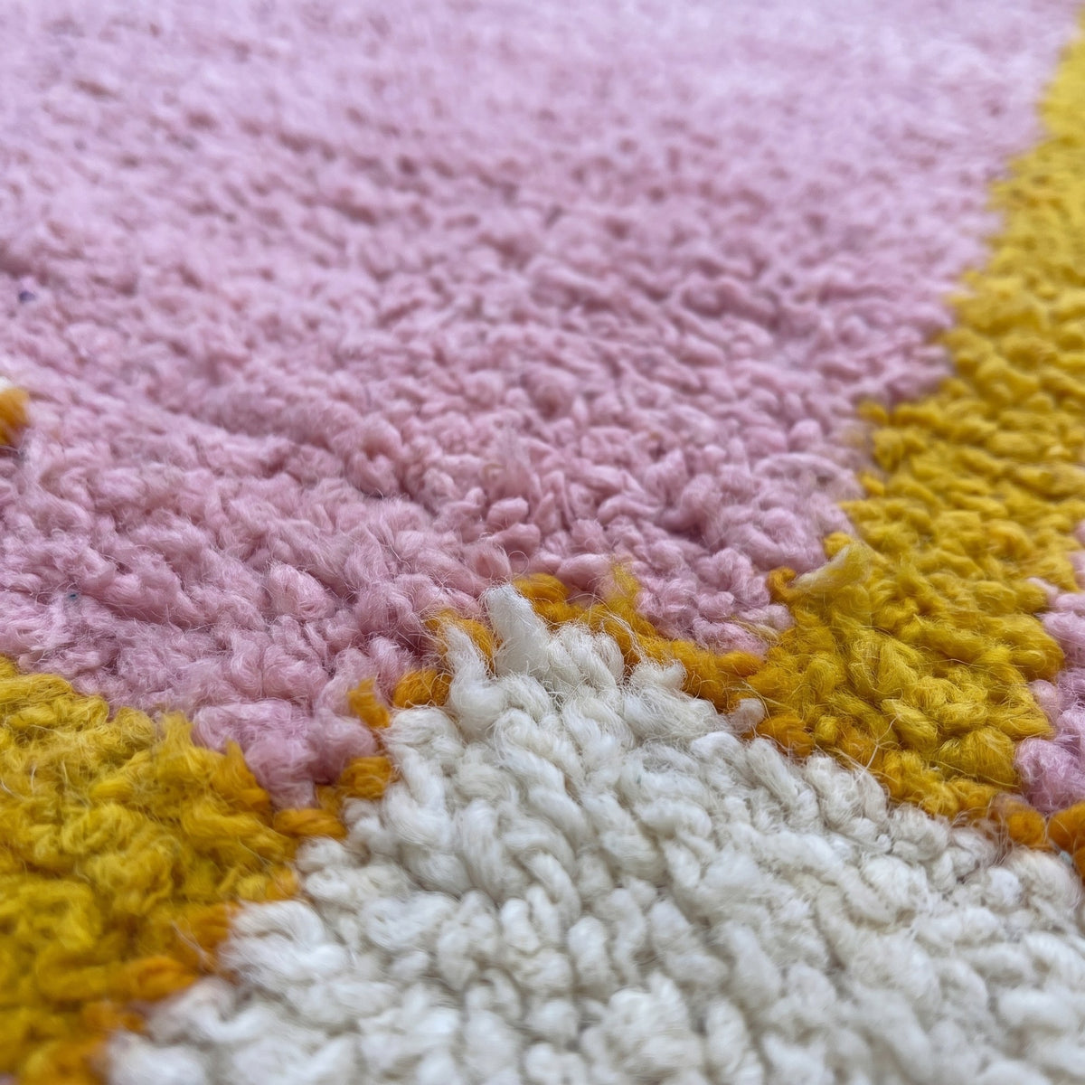 Close-up of a motif on the Berkane Berber runner, powder pink with a double orange border