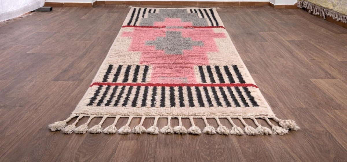 Timzila graphic Berber runner in pink and grey, on the floor, seen from the side, hand-knotted in Morocco