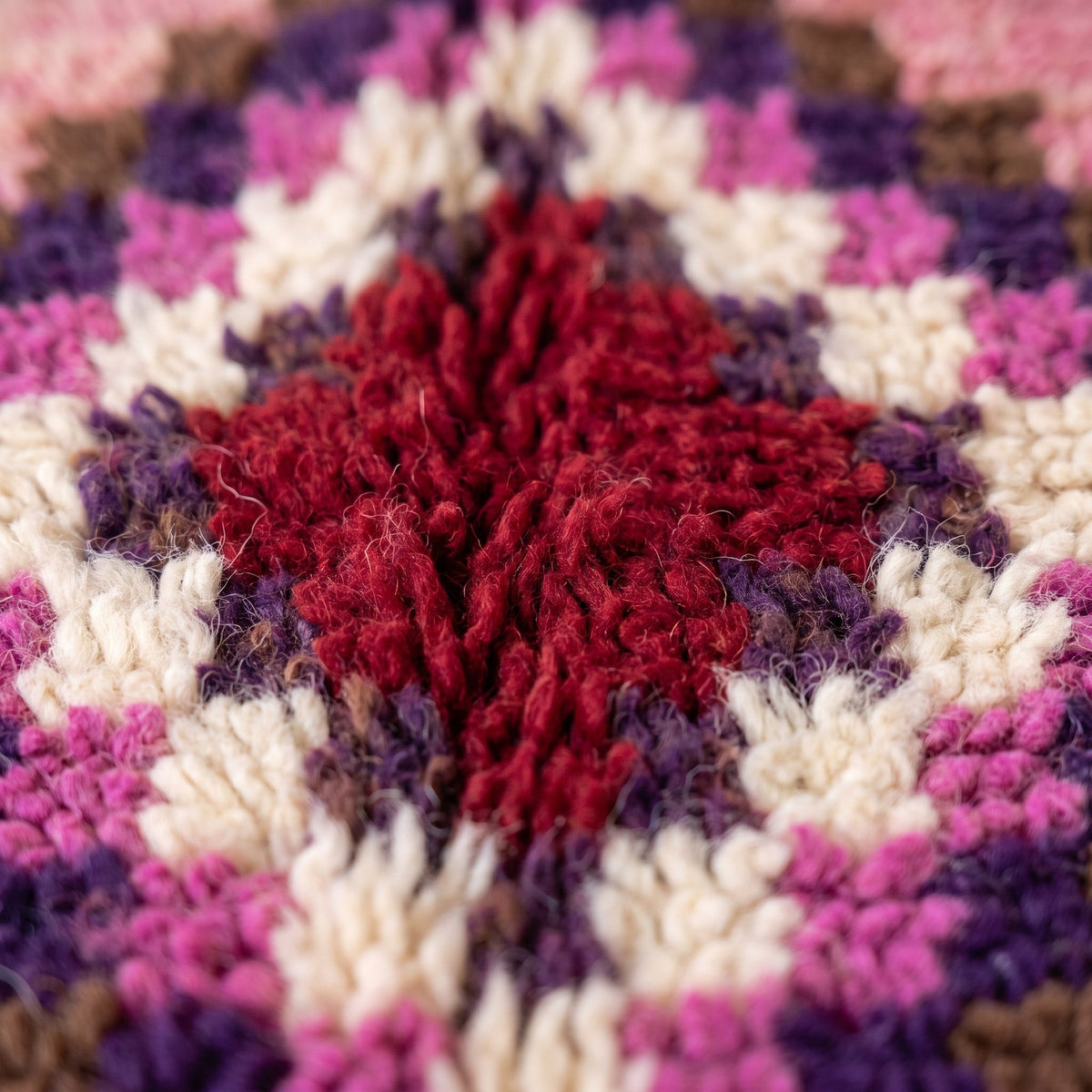 Gros plan sur un motif du tapis de couloir berbère Zoumi, couloir poil long, moitié gauche rose