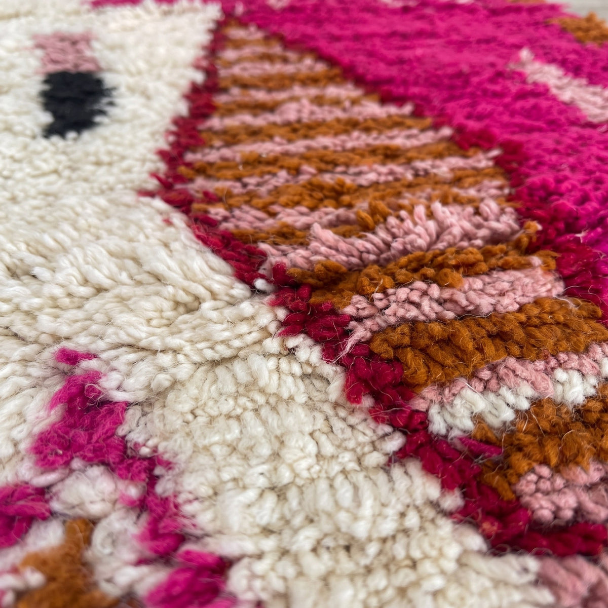 Gros plan sur un motif du tapis de couloir berbère Anoura, couloir à poil long, moitié gauche écrue