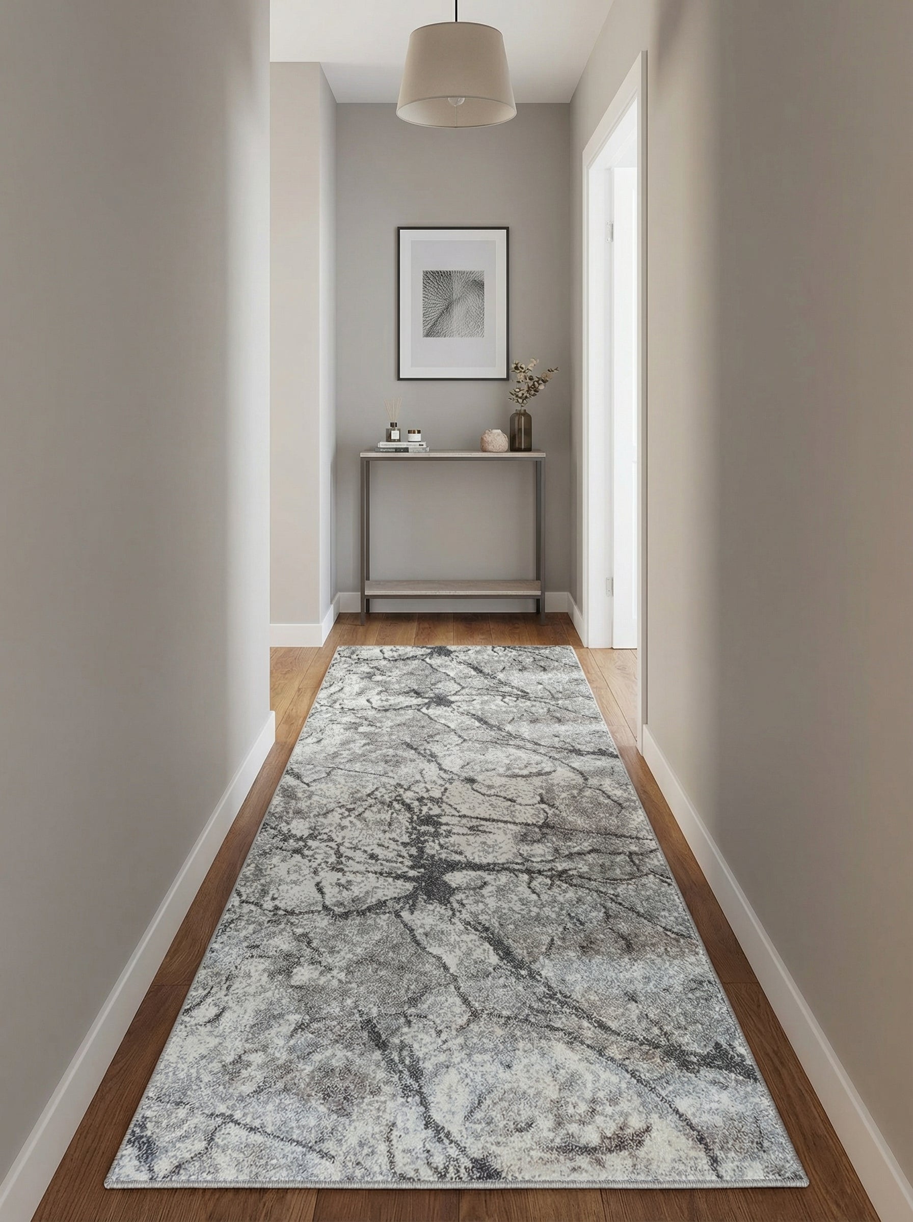 Tapis coureur gris clair, blanc et anthracite aux motifs abstraits façon marbre, sur parquet dans un couloir moderne