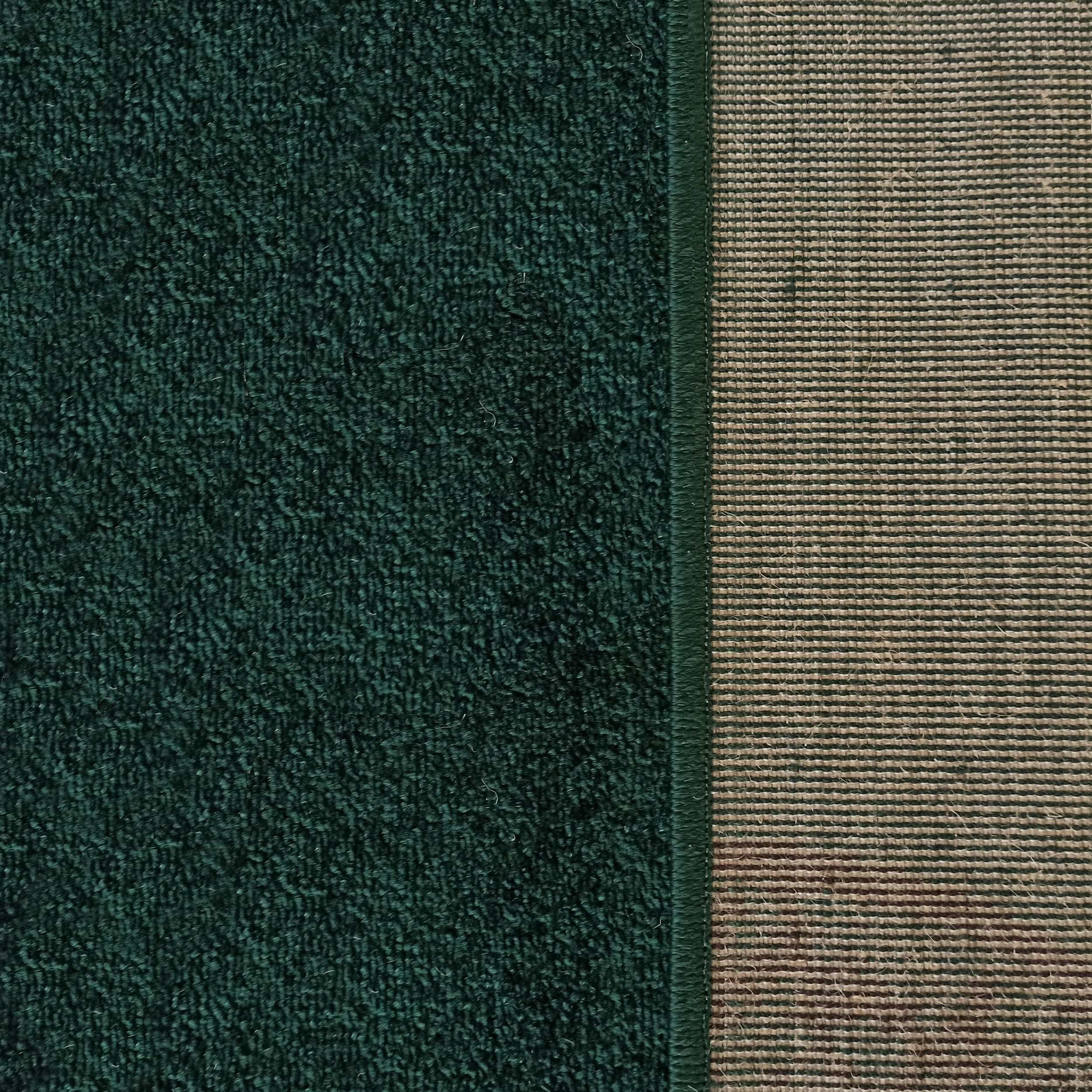 Surface en tissu vert foncé et texturé à gauche, avec une bande tissée à rayures horizontales vertes et beiges à droite