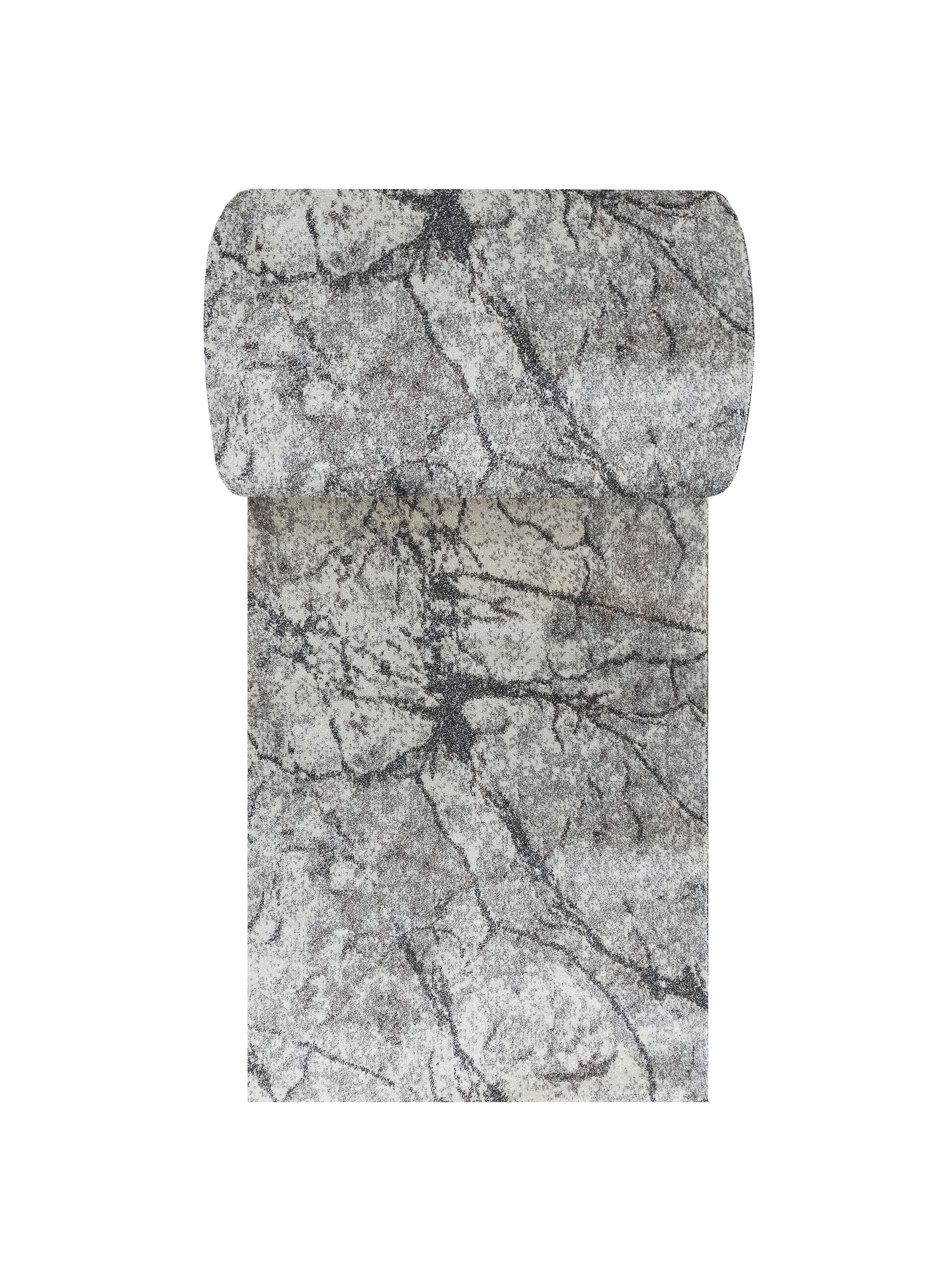 Tapis textile aux tons gris et blancs, avec des motifs de veinures irrégulières sombres, partiellement roulé