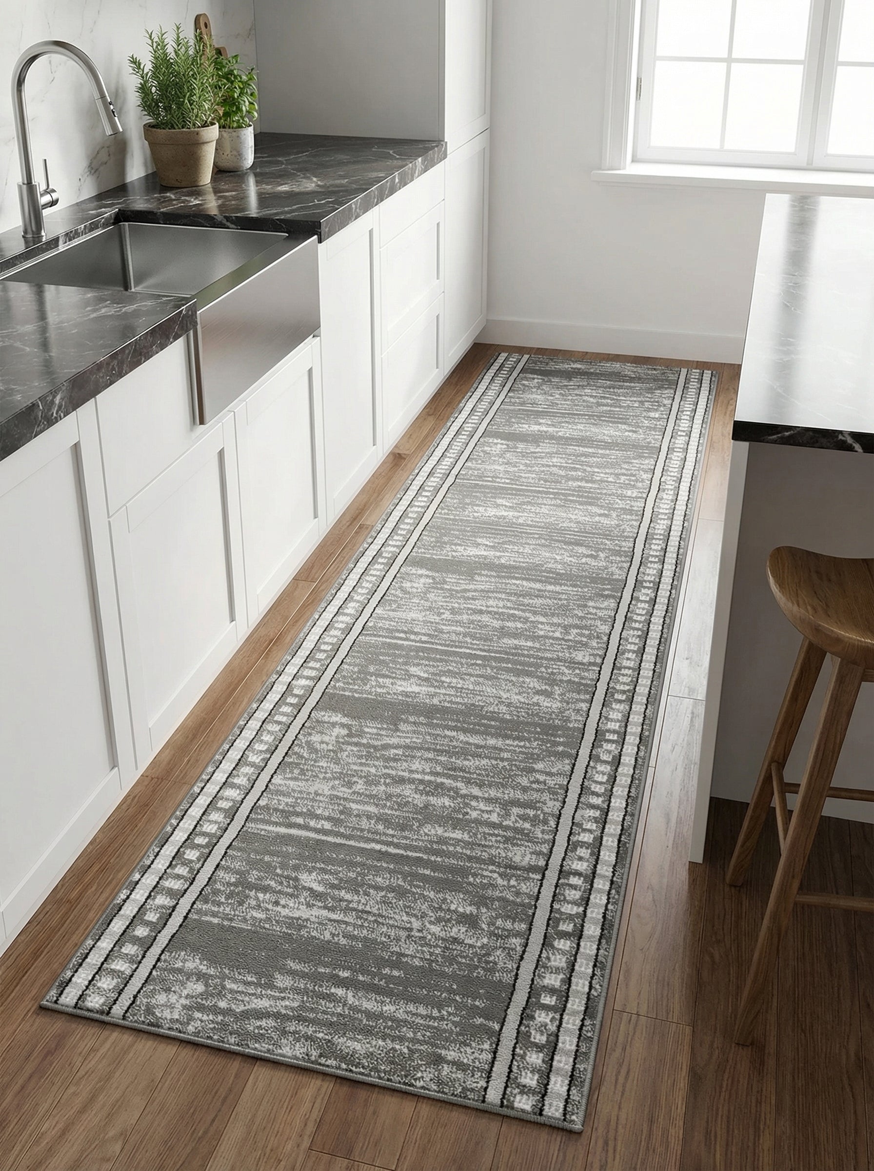 Tapis de couloir gris chiné à motifs abstraits, avec des bordures géométriques noires et blanches, sur parquet dans une cuisine