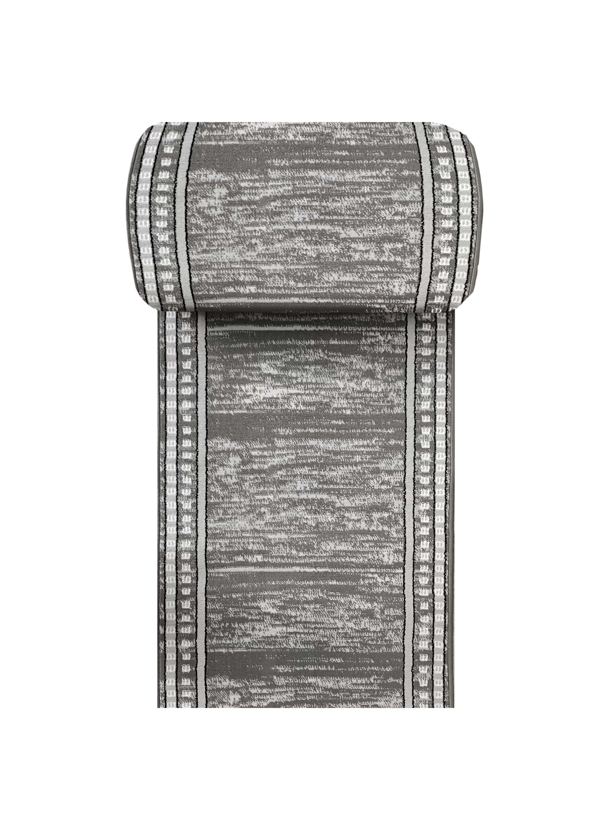 Tapis enroulé gris et blanc avec un motif texturé abstrait et des bandes latérales décoratives