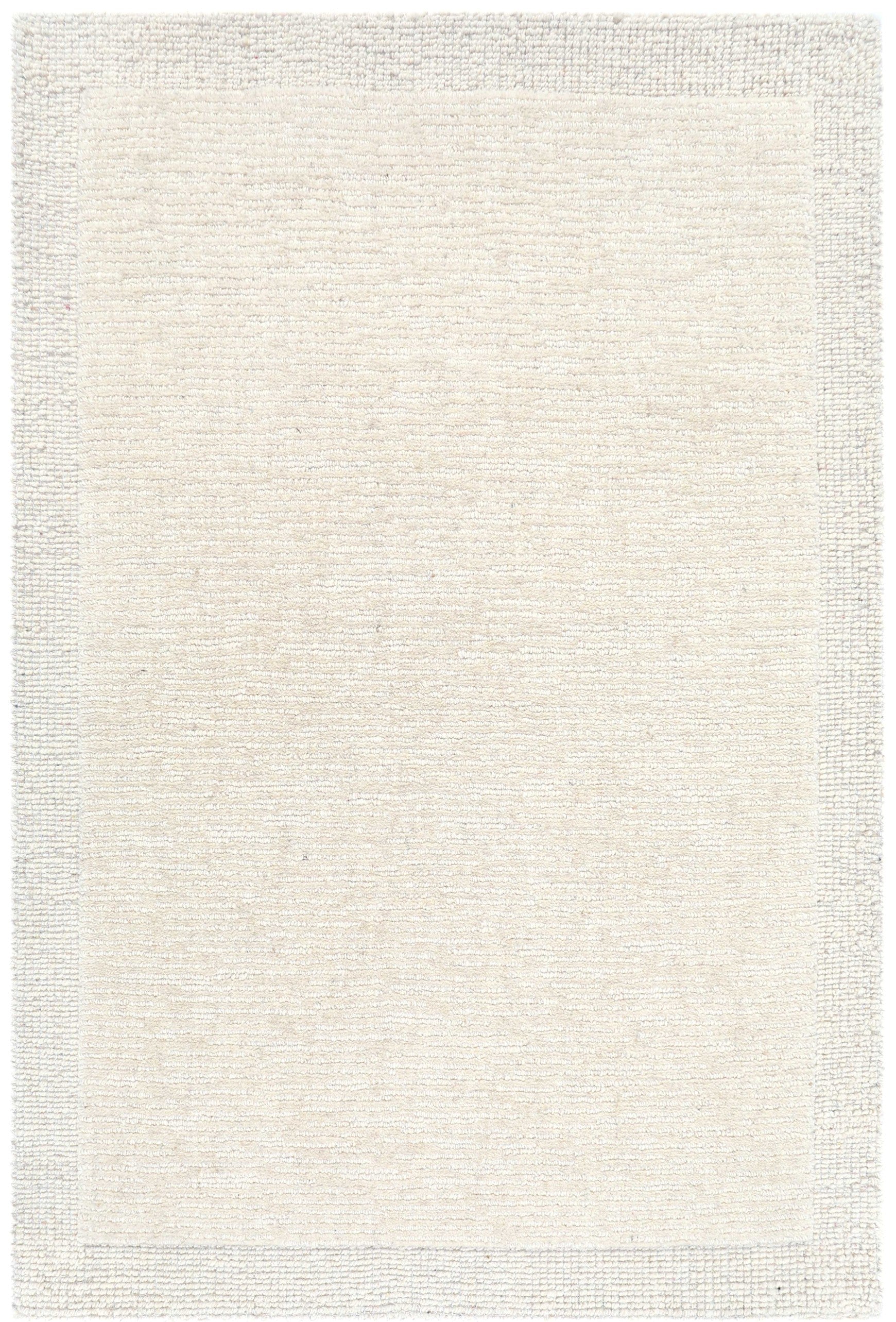 Tapis rectangulaire à motif texturé, tons crème et beige, ambiance neutre et chaleureuse