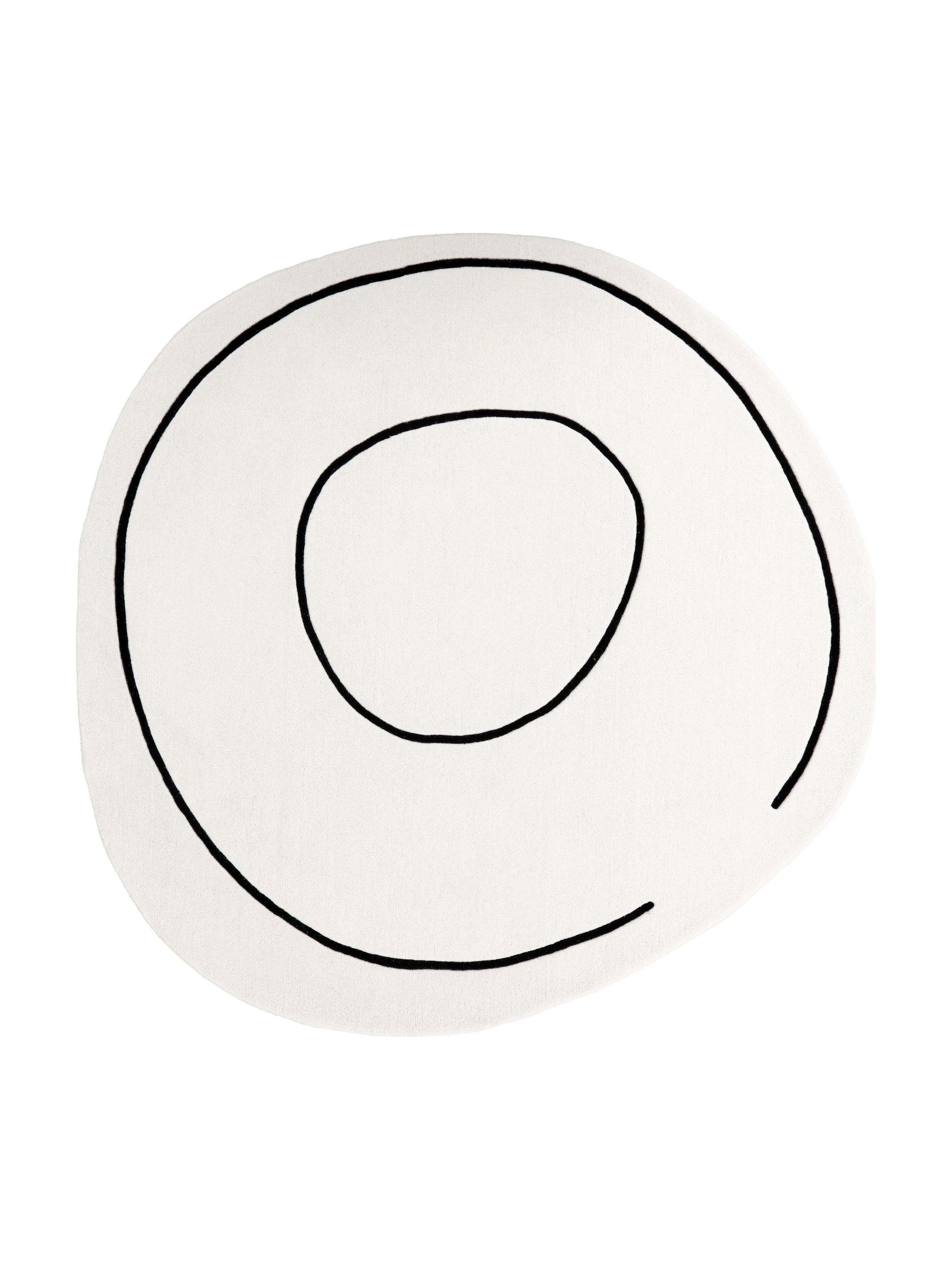Tapis de type rond, motif abstrait noir sur ivoire, pour une pièce