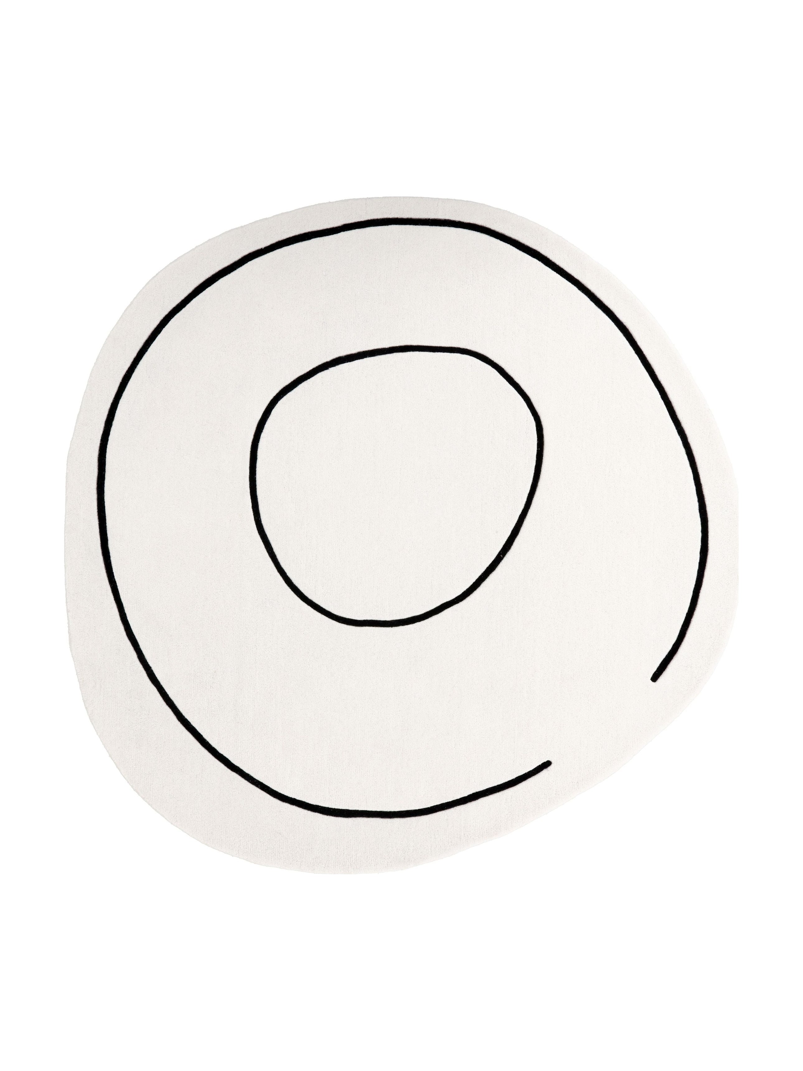 Tapis de type rond, motif abstrait noir sur ivoire, pour une pièce