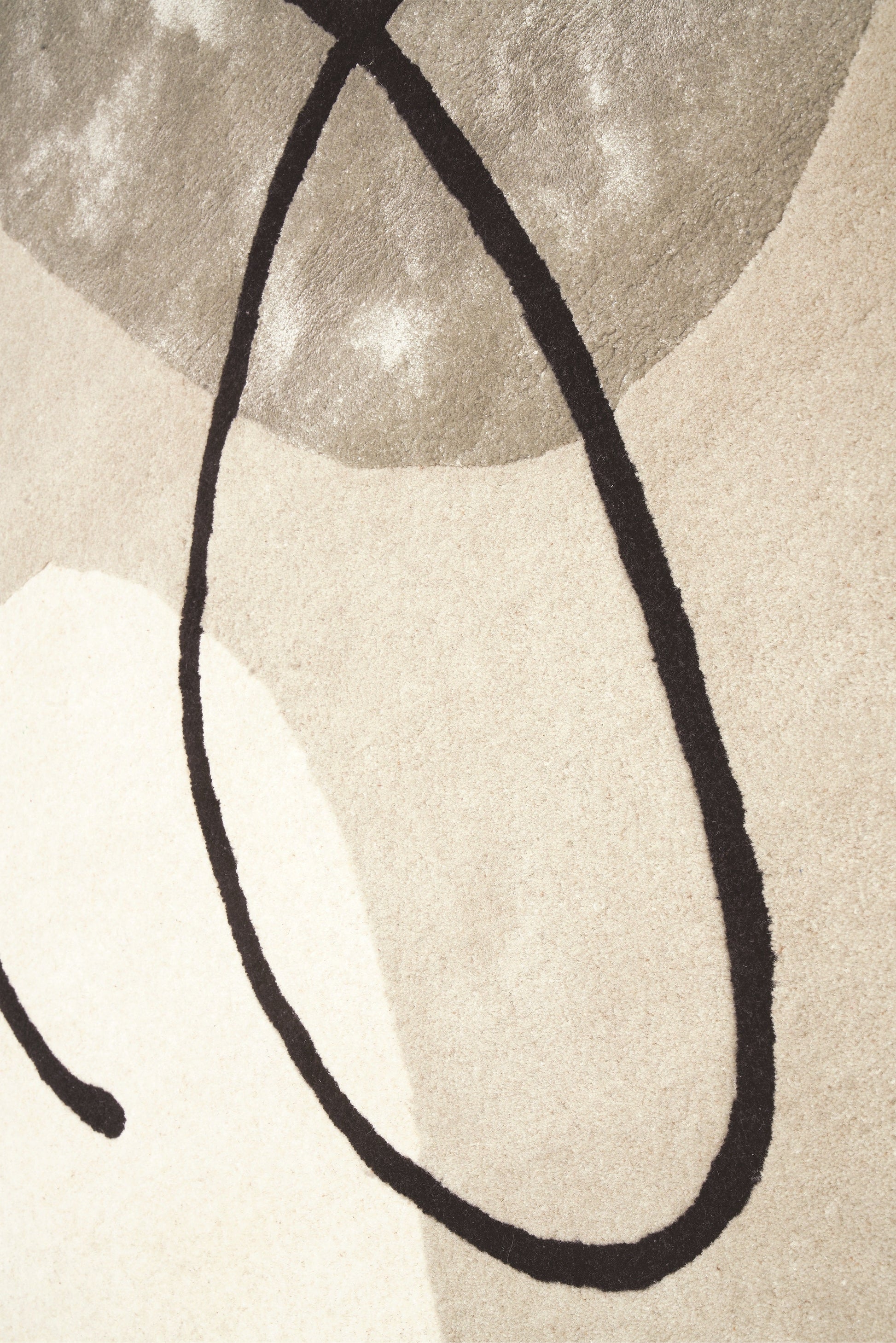 Tapis à tissage plat, texture douce et veloutée. Motifs abstraits noirs sur fond beige et gris clair. Ambiance sobre et