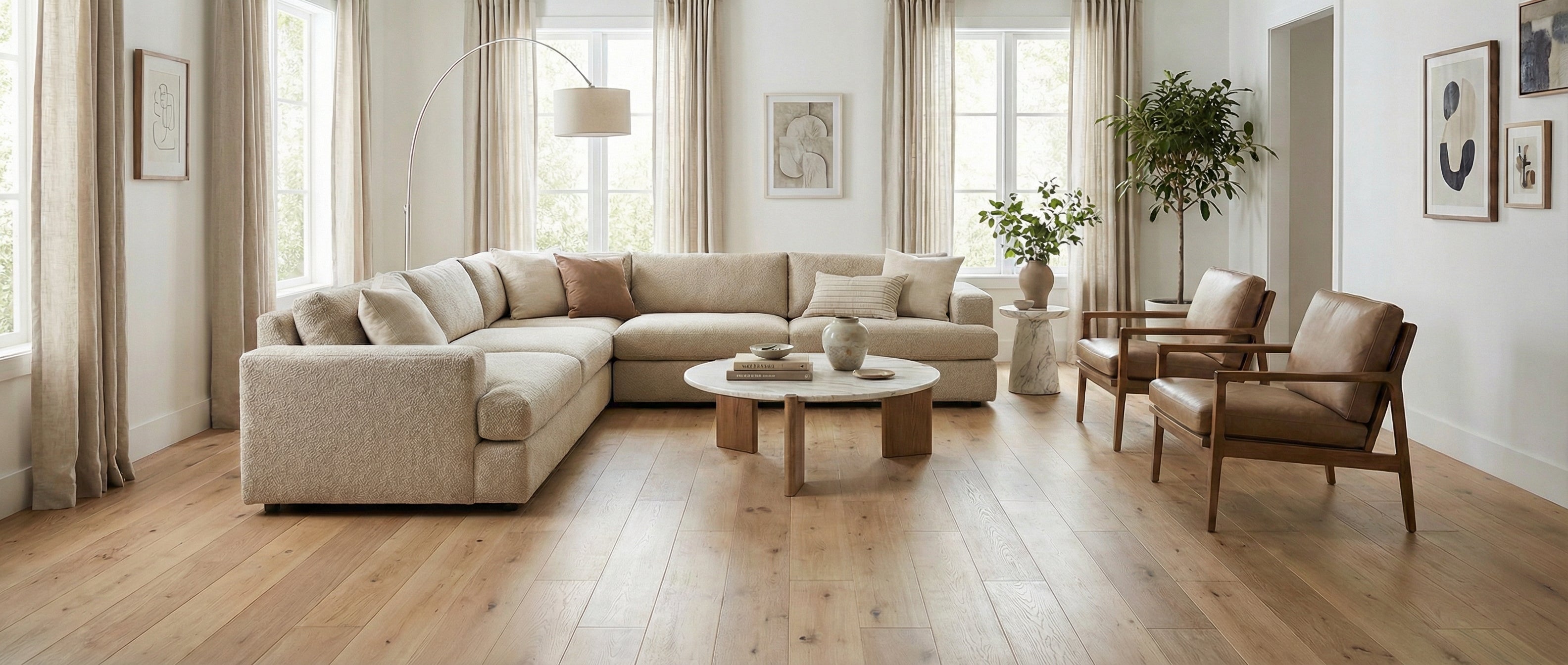 Pièce lumineuse avec parquet clair. Canapé beige, fauteuils en cuir. Espace vide pour un tapis rectangulaire, ambiance