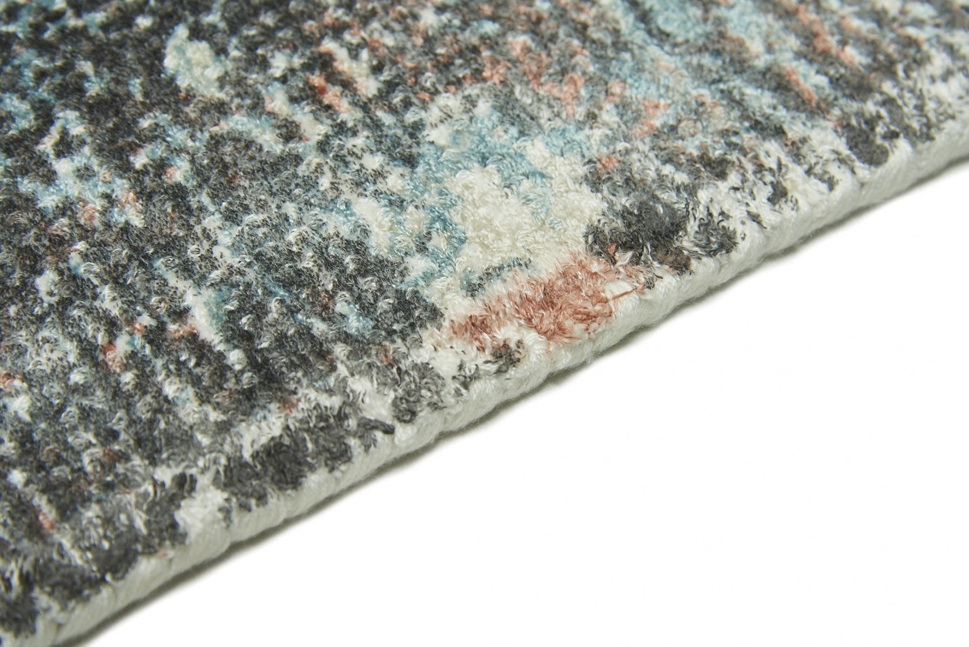 Détail texture du tapis Sintra Teal Peach. Tapis rectangulaire fait main avec fibres et tissage visibles.