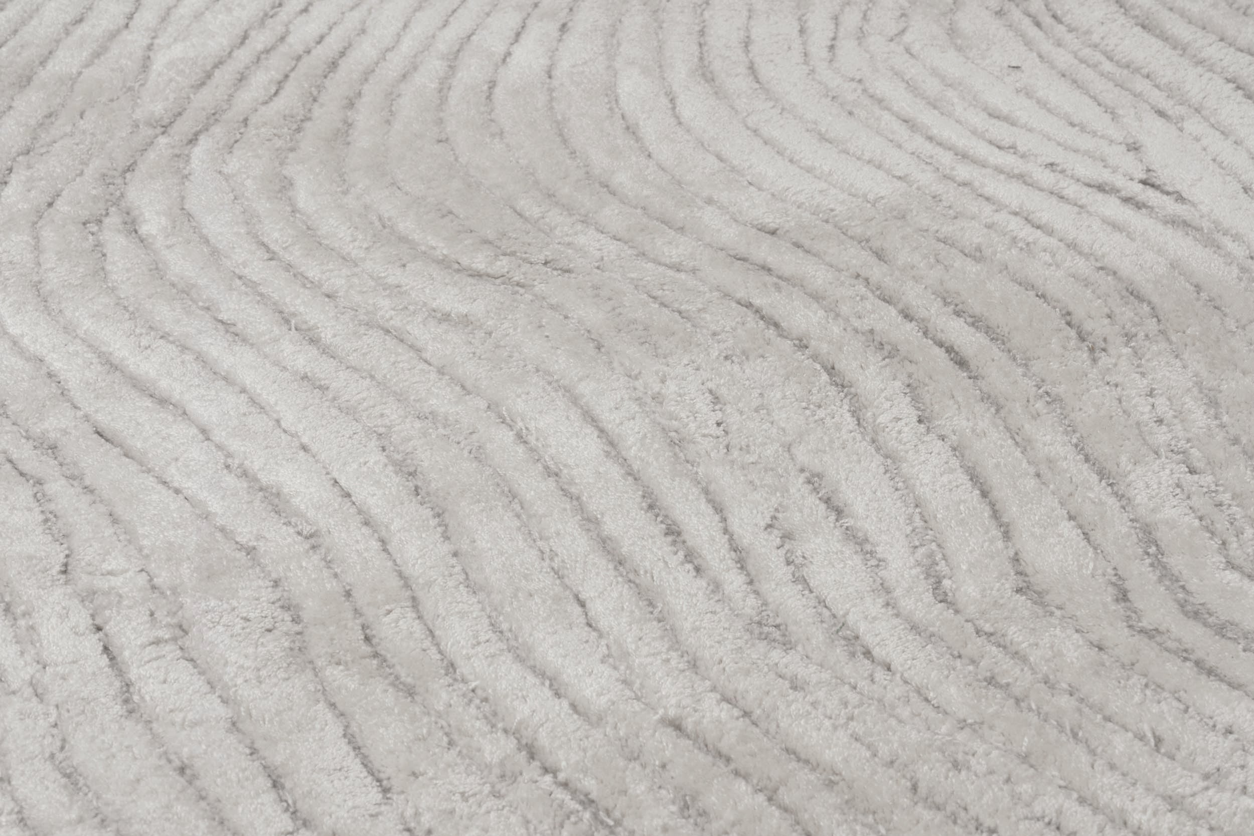 Tapis en viscose beige, tissage à relief rainuré. Type de pièce: rond