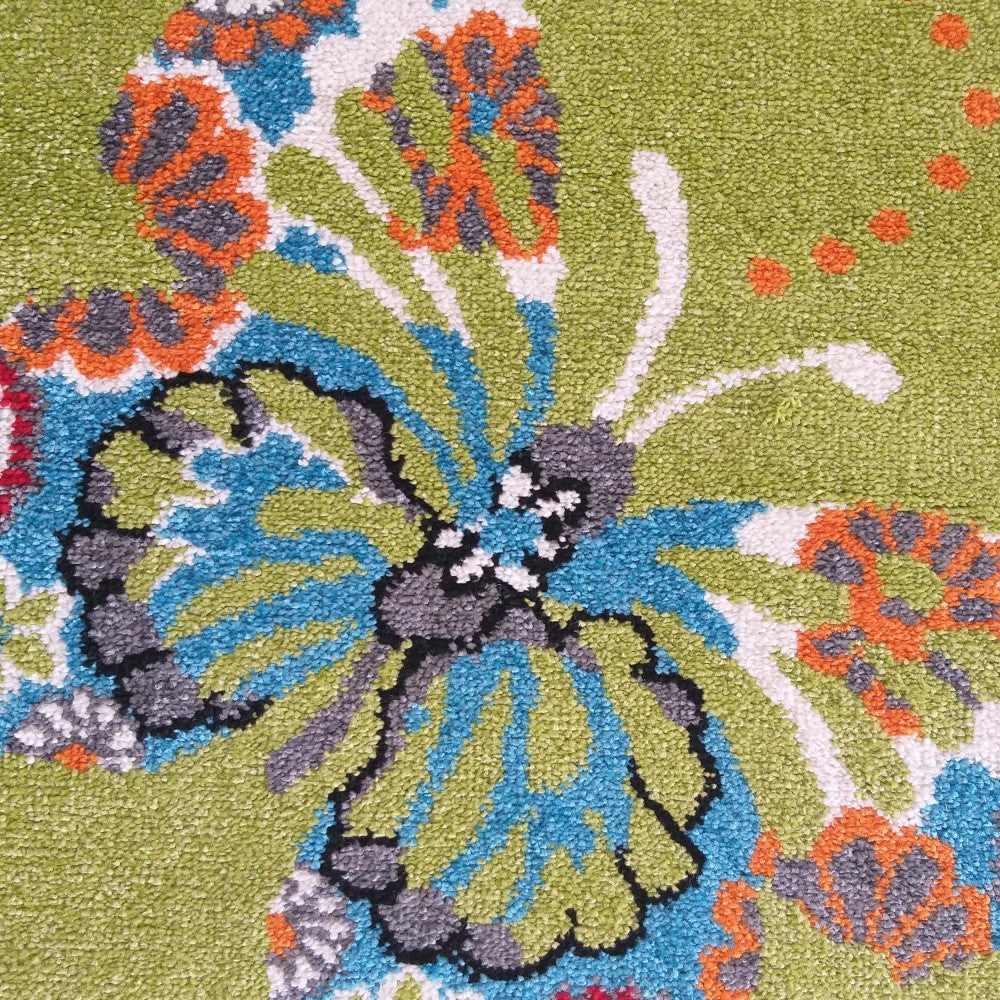 Tapis vert pomme moelleux avec un grand motif abstrait aux couleurs vives bleu, orange, gris et blanc