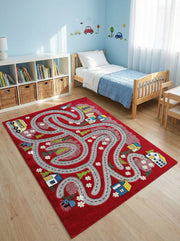 Tapis de jeu rectangulaire rouge avec motif de routes grises, maisons, arbres et véhicules, dans une chambre d'enfant