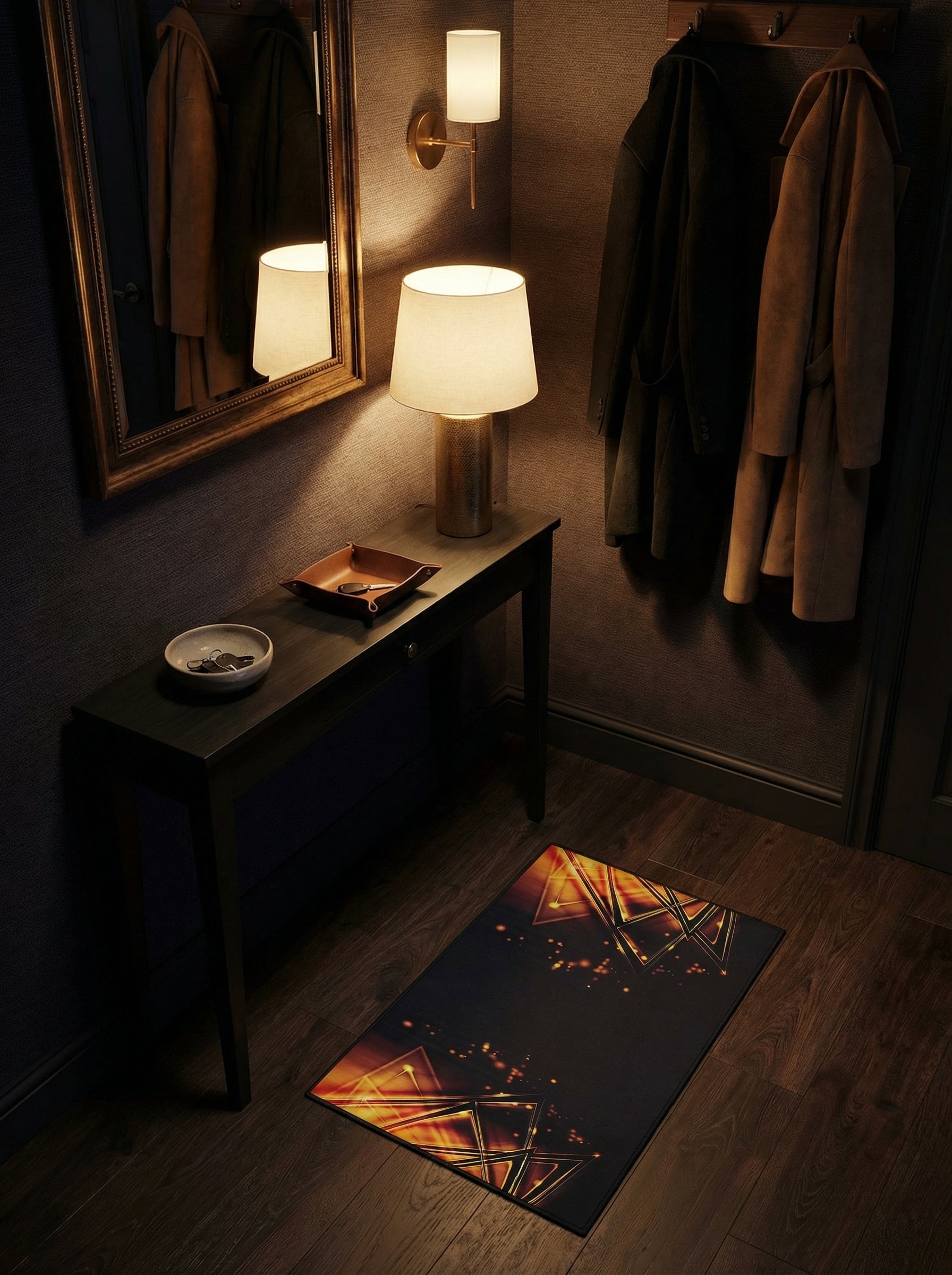 Tapis rectangulaire noir aux motifs géométriques lumineux triangulaires orange et or, posé sur un parquet dans un couloir d'entrée sombre