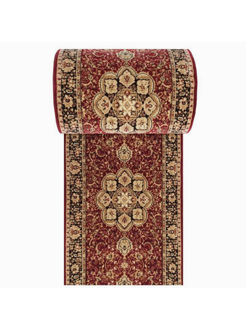 Tapis bordeaux à motifs floraux et arabesques traditionnels beiges et noirs, partiellement enroulé en haut