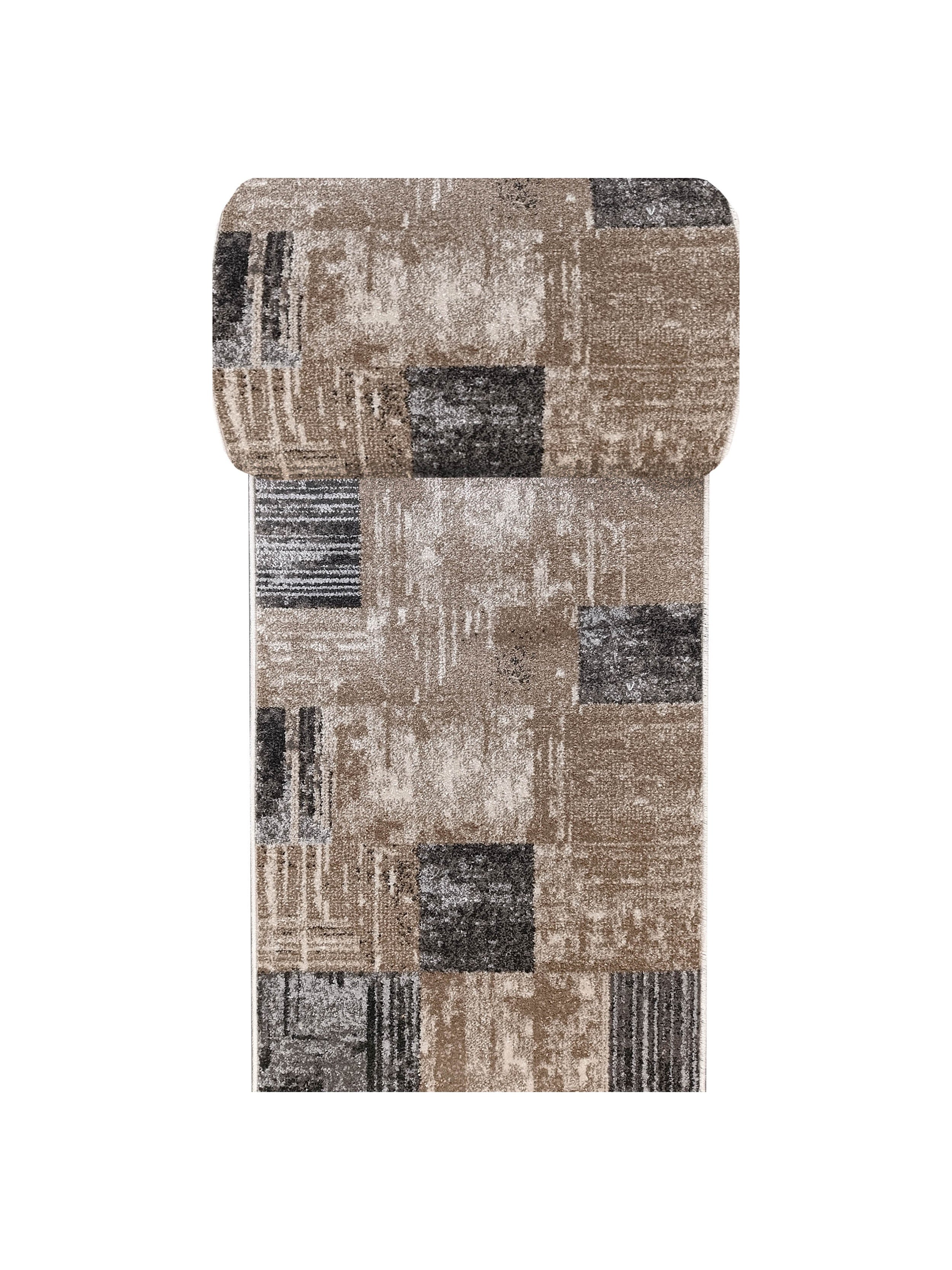 Un tapis de couloir enroulé, au motif abstrait de blocs et de rayures texturées beige, marron, gris et noir