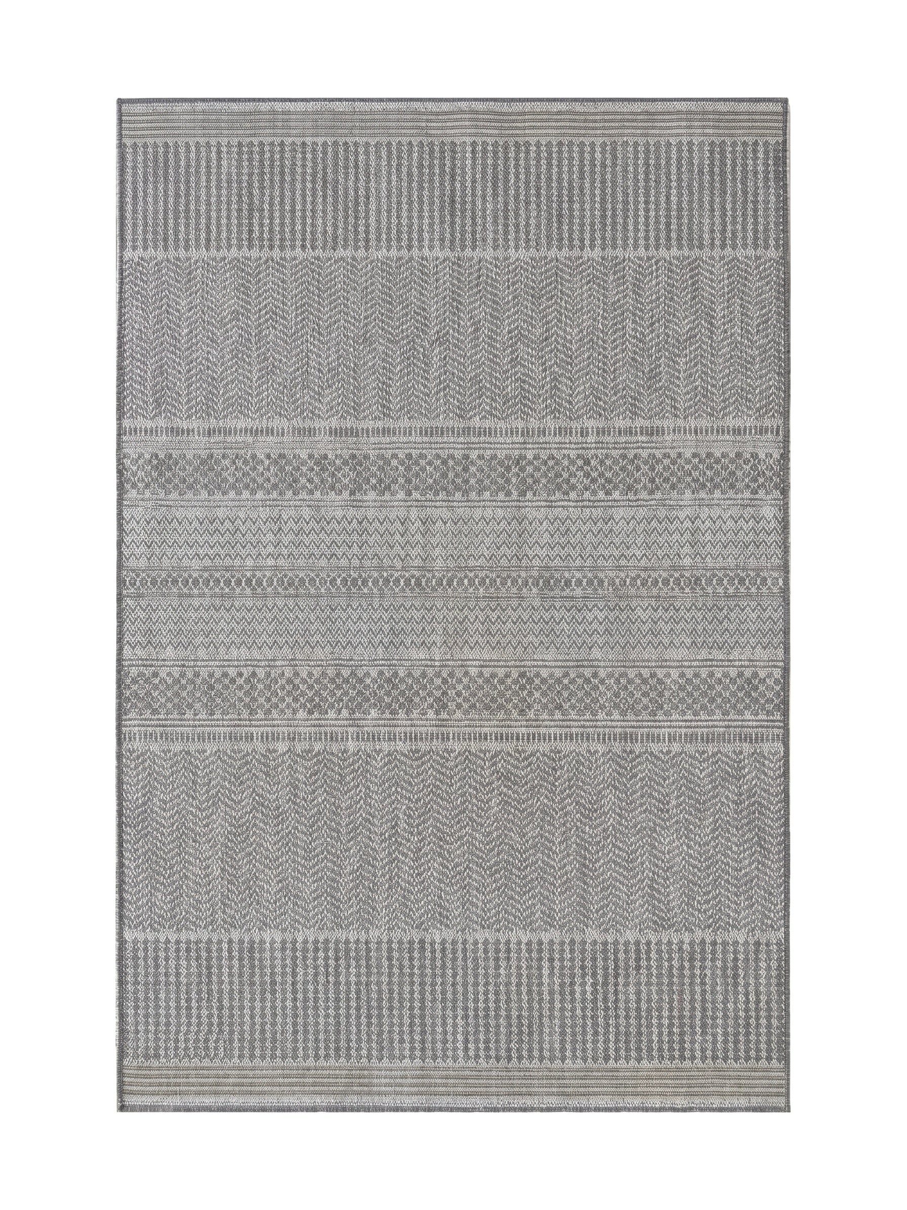 Tapis rectangulaire aux motifs géométriques tissés, avec des bandes horizontales de chevrons et rayures en différentes nuances de gris