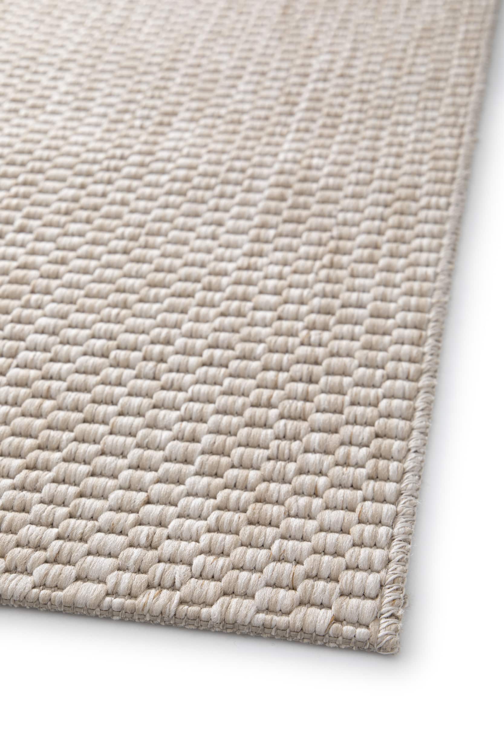 Bordure de tapis beige clair, finition simple. Tissage serré, aspect texturé