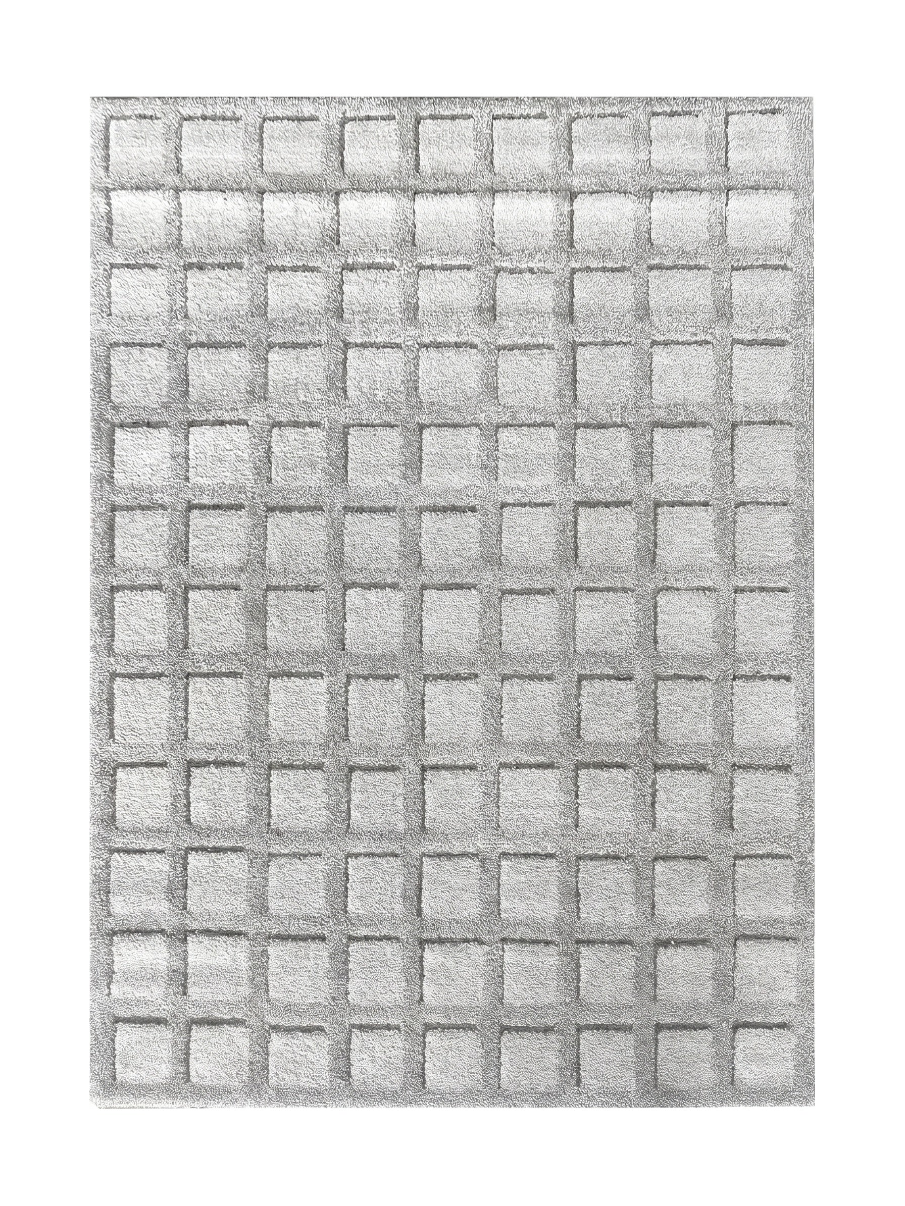 Tapis doux gris clair avec un motif en relief formant une grille de carrés texturés