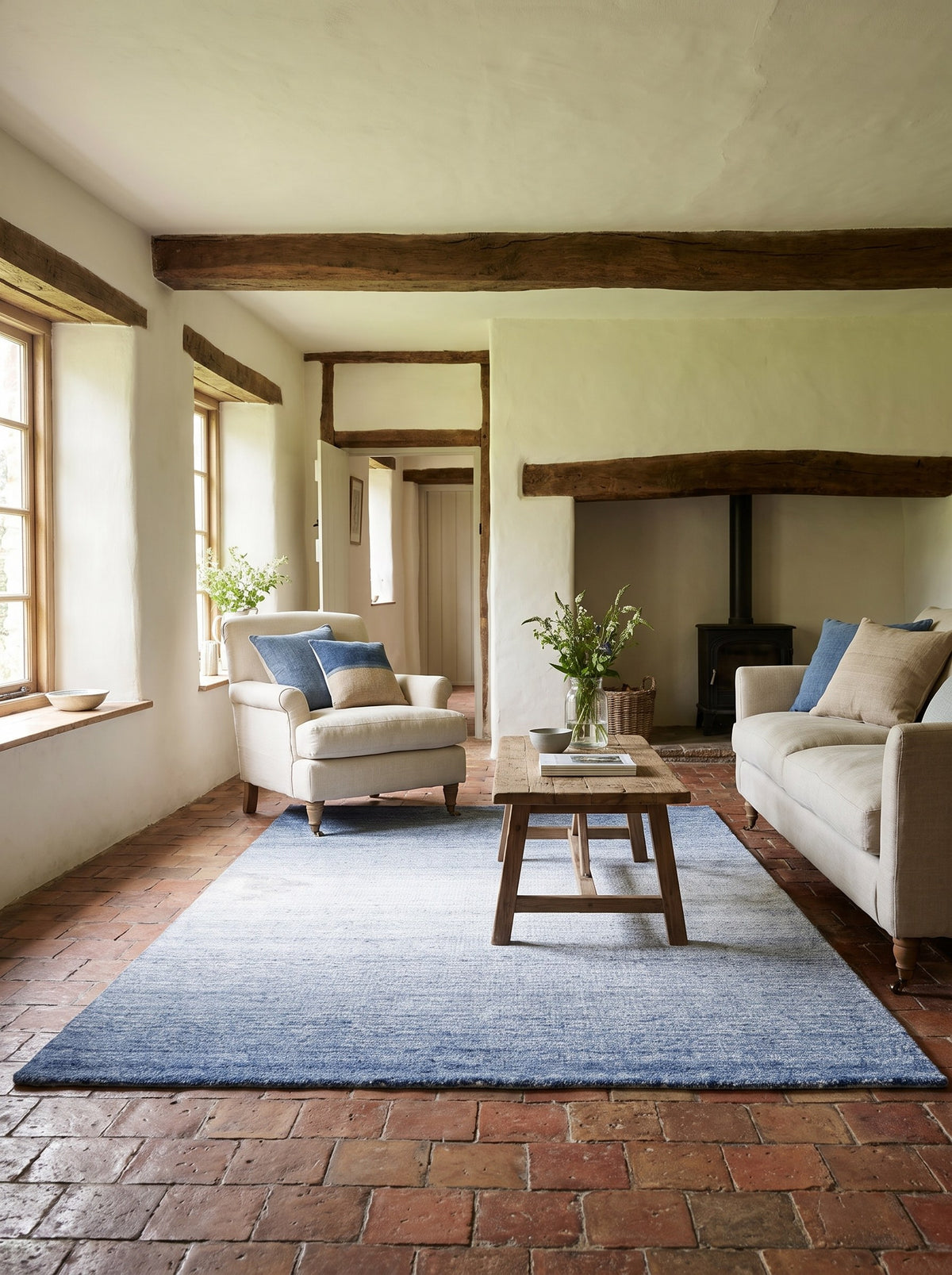 Navy Blue Wool & Viscose Rug - Mattino at the centre of a farmhouse living room, on old terracotta floor tiles