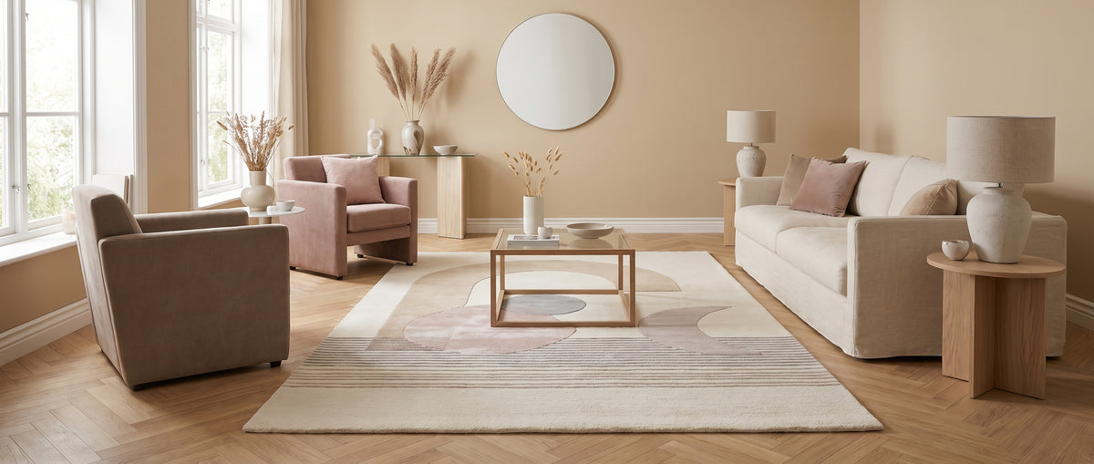 Tapis ivoire tufté main en laine et viscose, aux motifs abstraits beige, rose poudré et gris en relief, dans un salon
