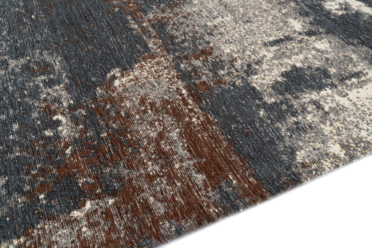 The textured fibre grain of an abstract washable rug blends slate blue, brown and cream