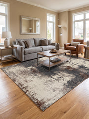 A washable rug with abstract, textured slate blue, brown, and cream patterns decorates a modern living room