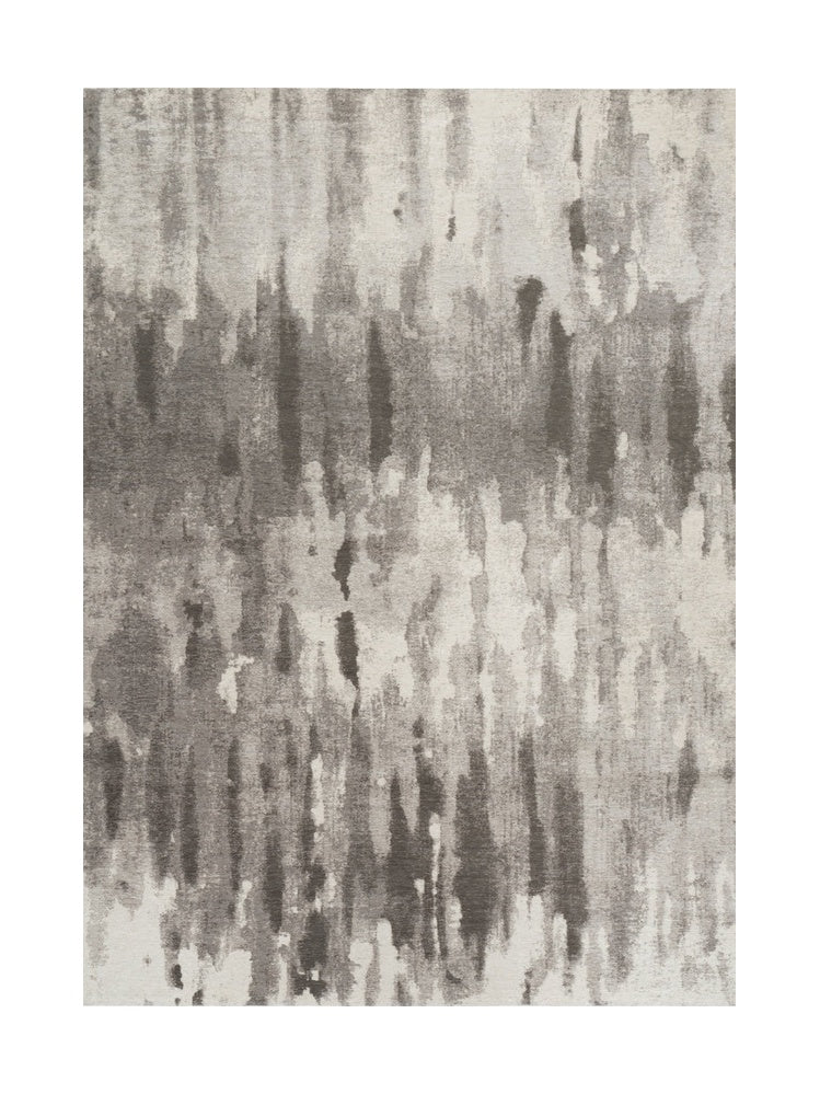 Tapis rectangulaire avec motif abstrait en nuances de gris, créant une ambiance moderne et épurée