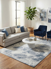 Tapis rectangulaire gris et bleu dans un salon. Ambiance douce et harmonieuse avec le décor