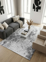 Tapis rectangulaire gris et blanc, ambiance moderne. Harmonie avec le décor épuré du salon