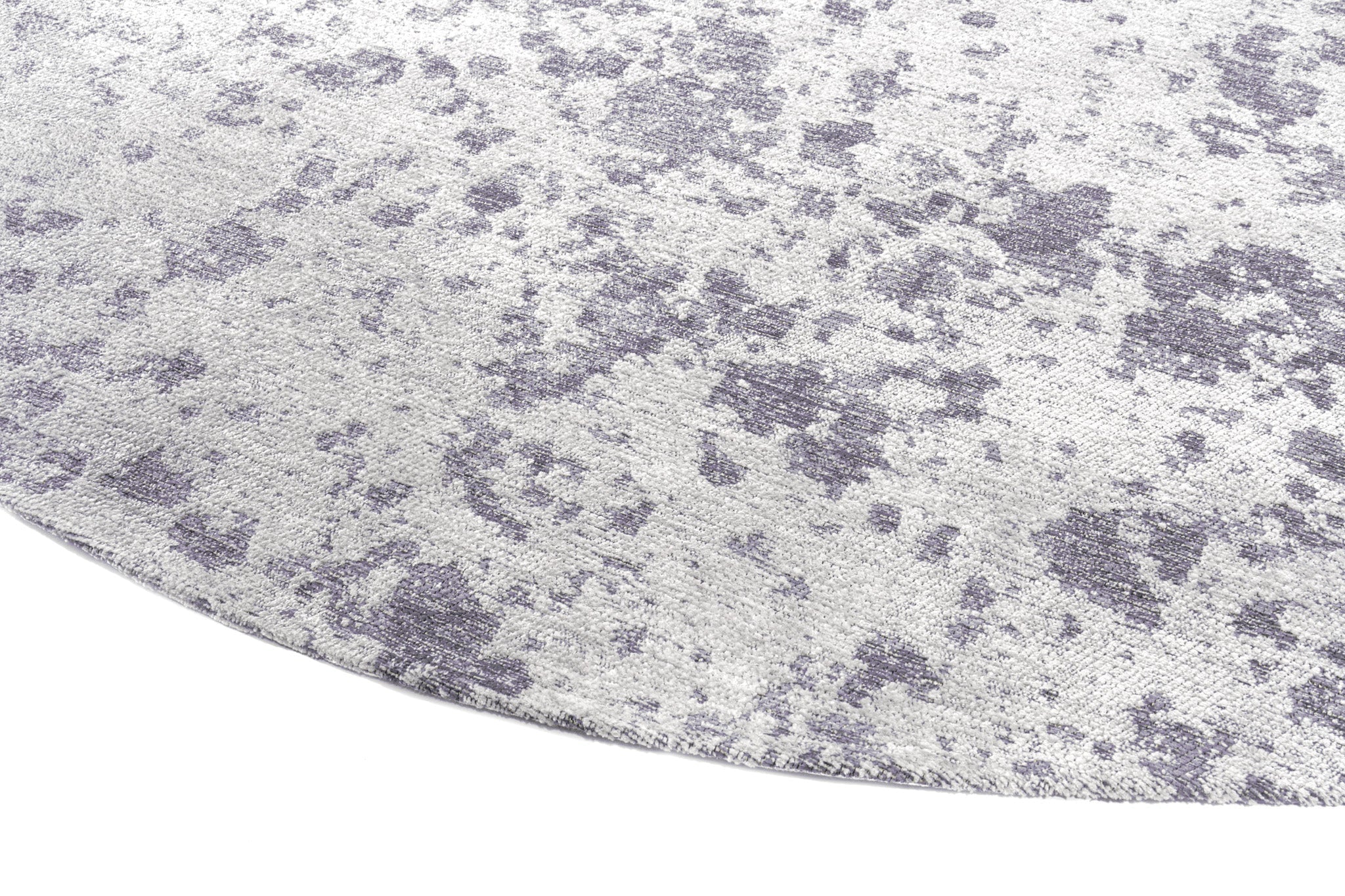 Tapis rond gris clair, tissage texturé avec des motifs irréguliers. Relief doux, aspect tactile velouté