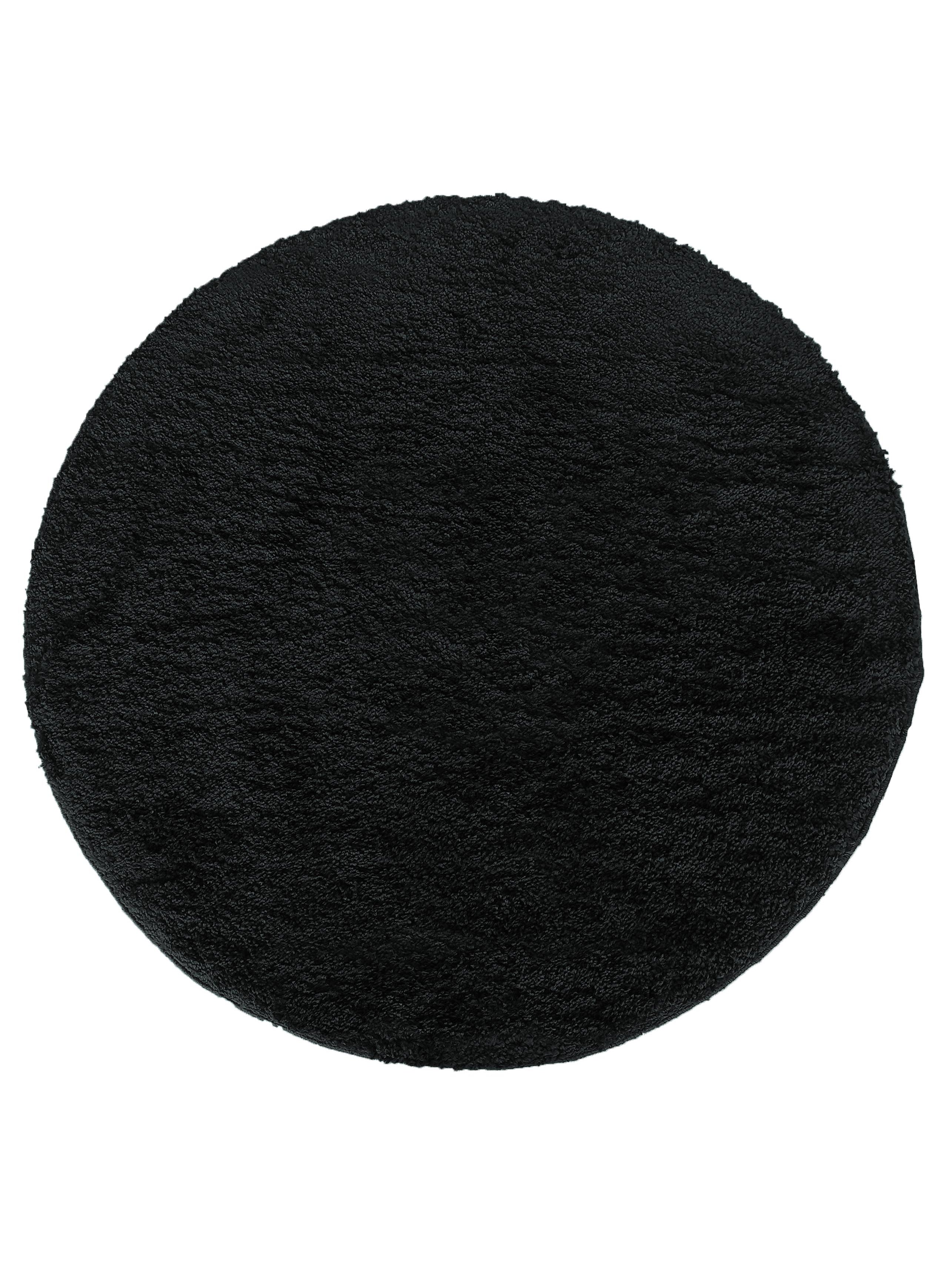 Tapis rond de couleur noire, présentant une texture douce et dense à poils longs ou bouclés