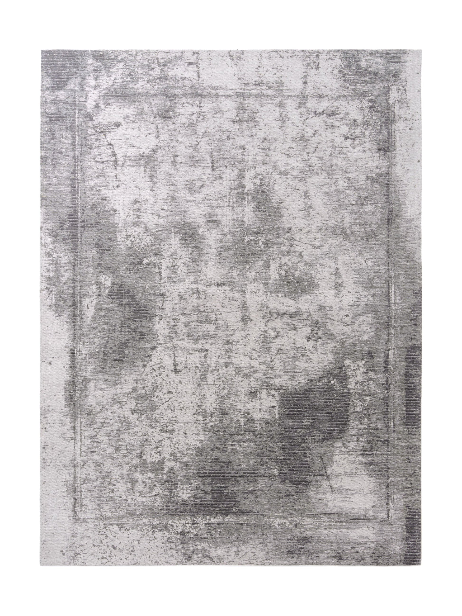 Tapis rectangulaire gris et blanc avec un motif texturé. Style contemporain, ambiance sobre