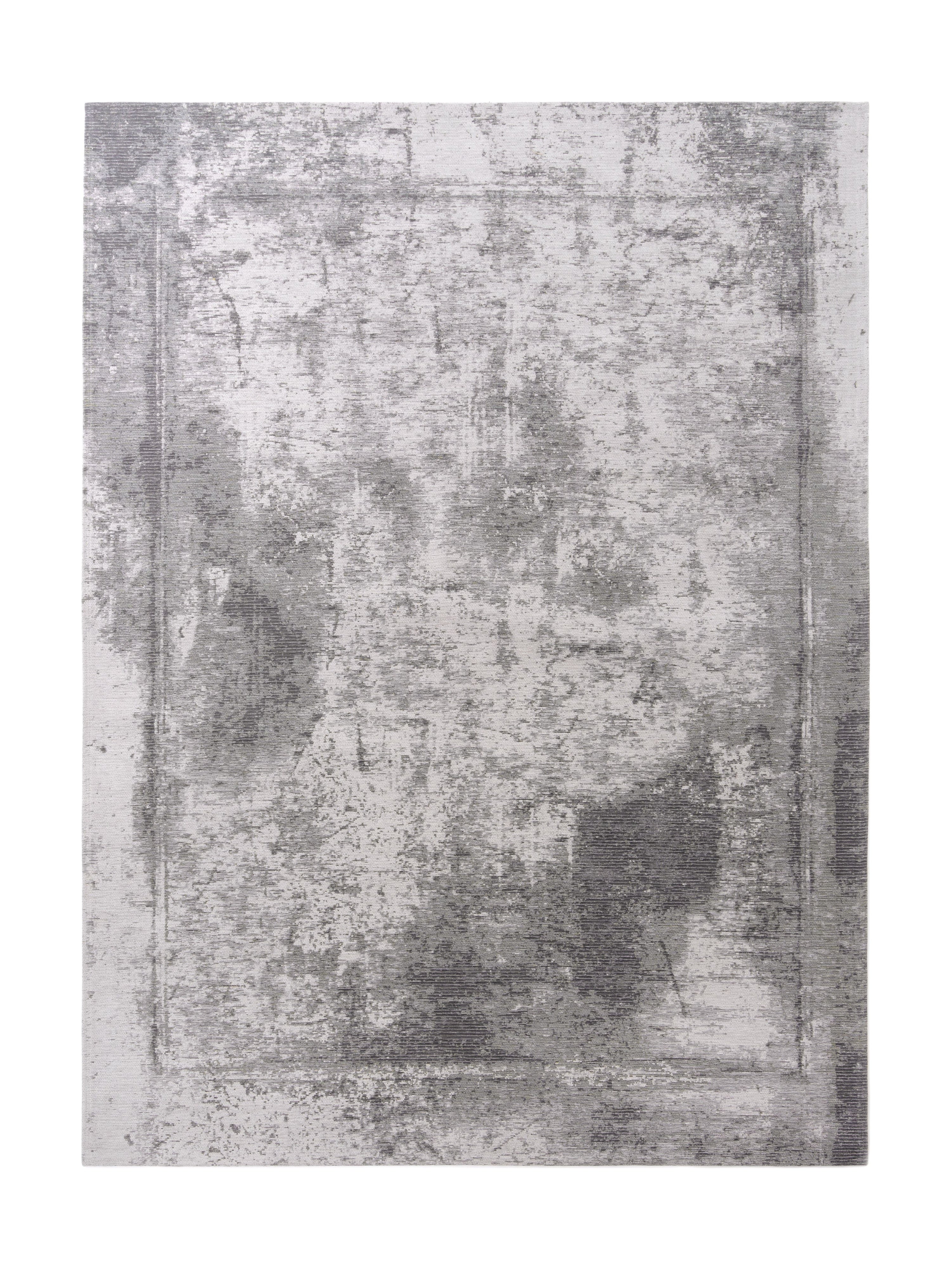 Tapis rectangulaire gris et blanc avec un motif texturé. Style contemporain, ambiance sobre