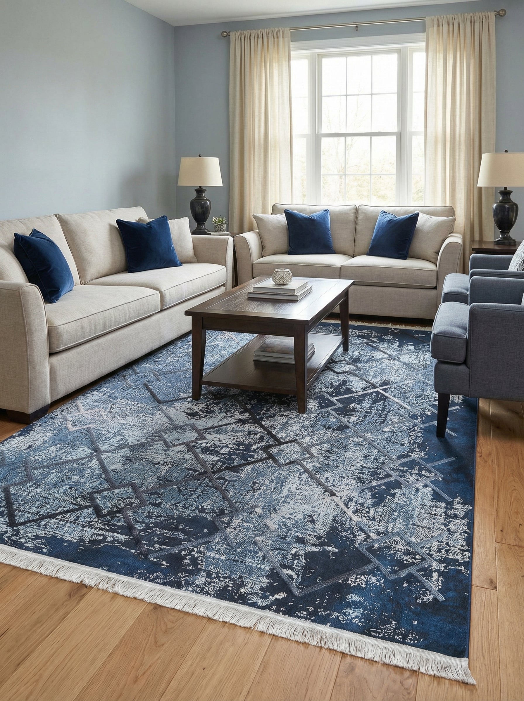 Tapis rectangulaire bleu foncé et clair avec des motifs abstraits usés et un quadrillage géométrique, bordé de franges, posé dans un salon