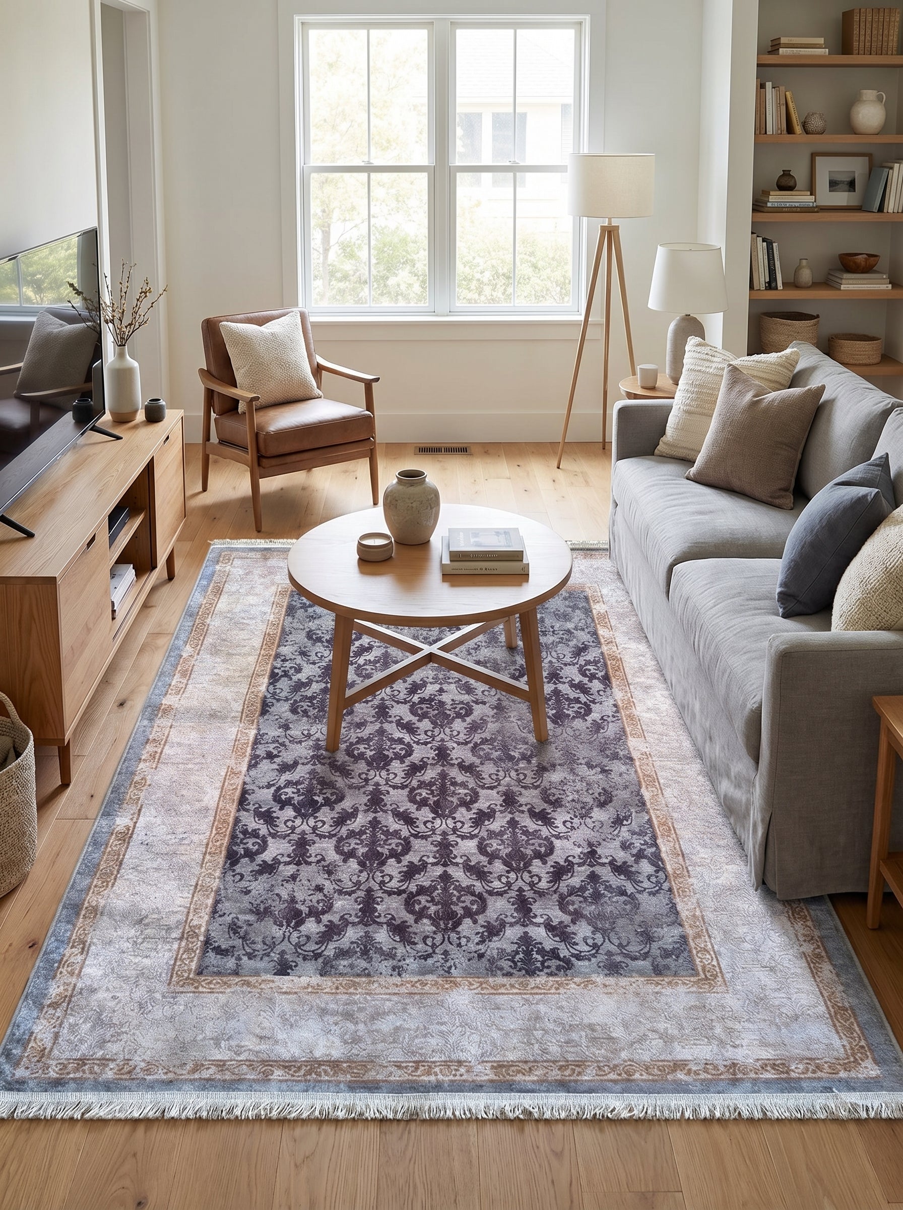 Tapis rectangulaire à motifs damassés aubergine sur fond gris clair, avec bordures beiges, bleues et dorées, dans un salon moderne