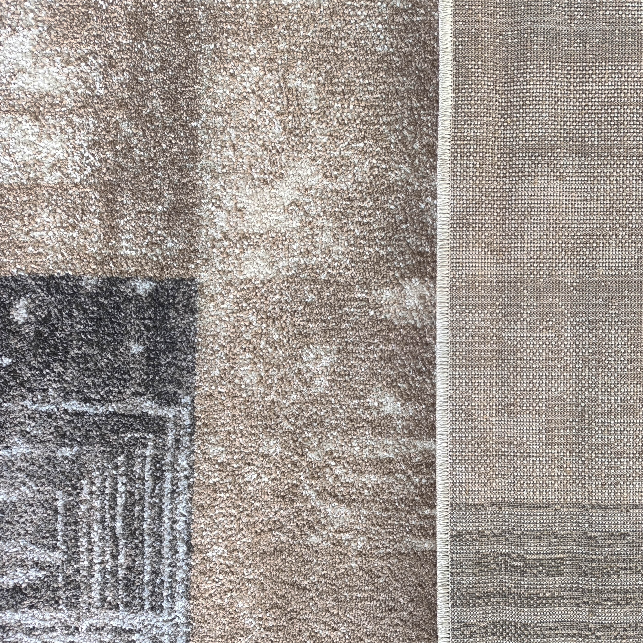 Tapis à poils longs marron, beige et gris foncé avec des motifs abstraits, juxtaposé à un revers tissé plus clair