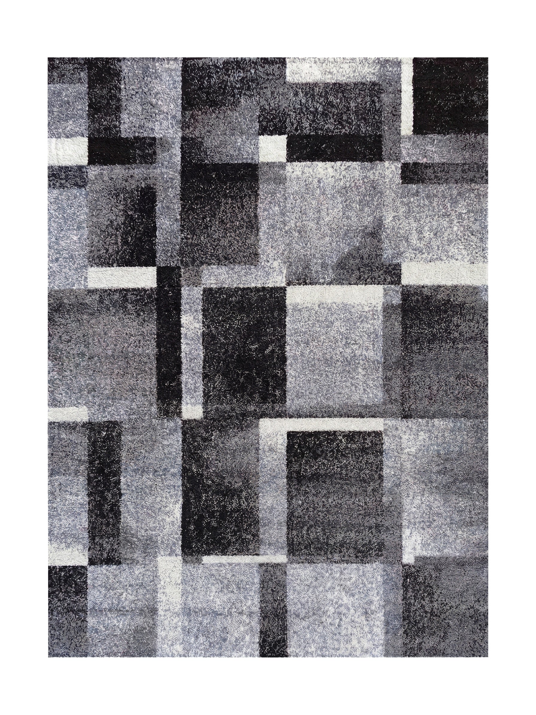 Tapis aux motifs géométriques de carrés et rectangles noirs, gris clairs, gris foncés et blancs, avec une texture douce