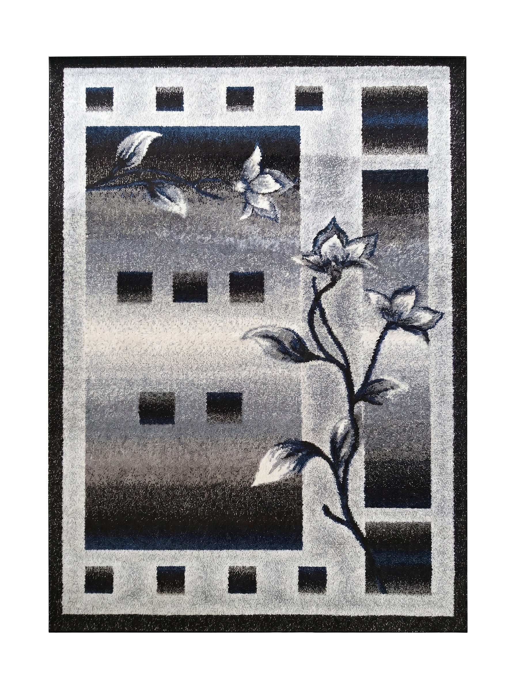 Tapis rectangulaire aux motifs floraux et géométriques. Il présente un dégradé de couleurs gris, noir et blanc, avec des touches de bleu sur les fleurs et des formes rectangulaires foncées
