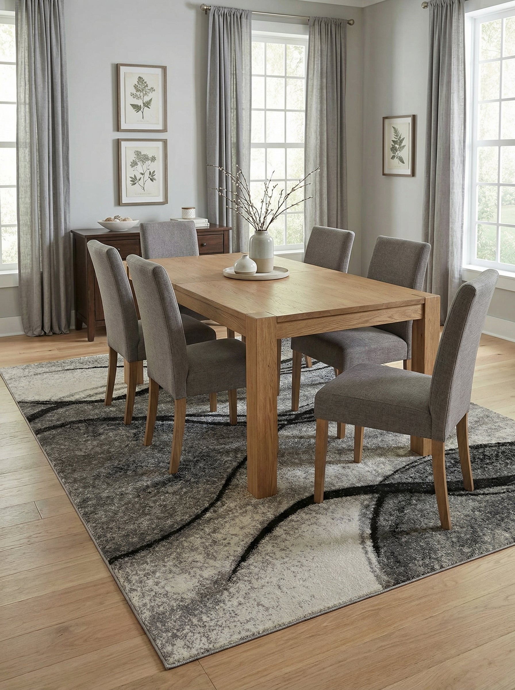 Tapis rectangulaire à motifs abstraits gris, blancs et noirs, avec des courbes fluides et une texture mouchetée, dans une salle à manger
