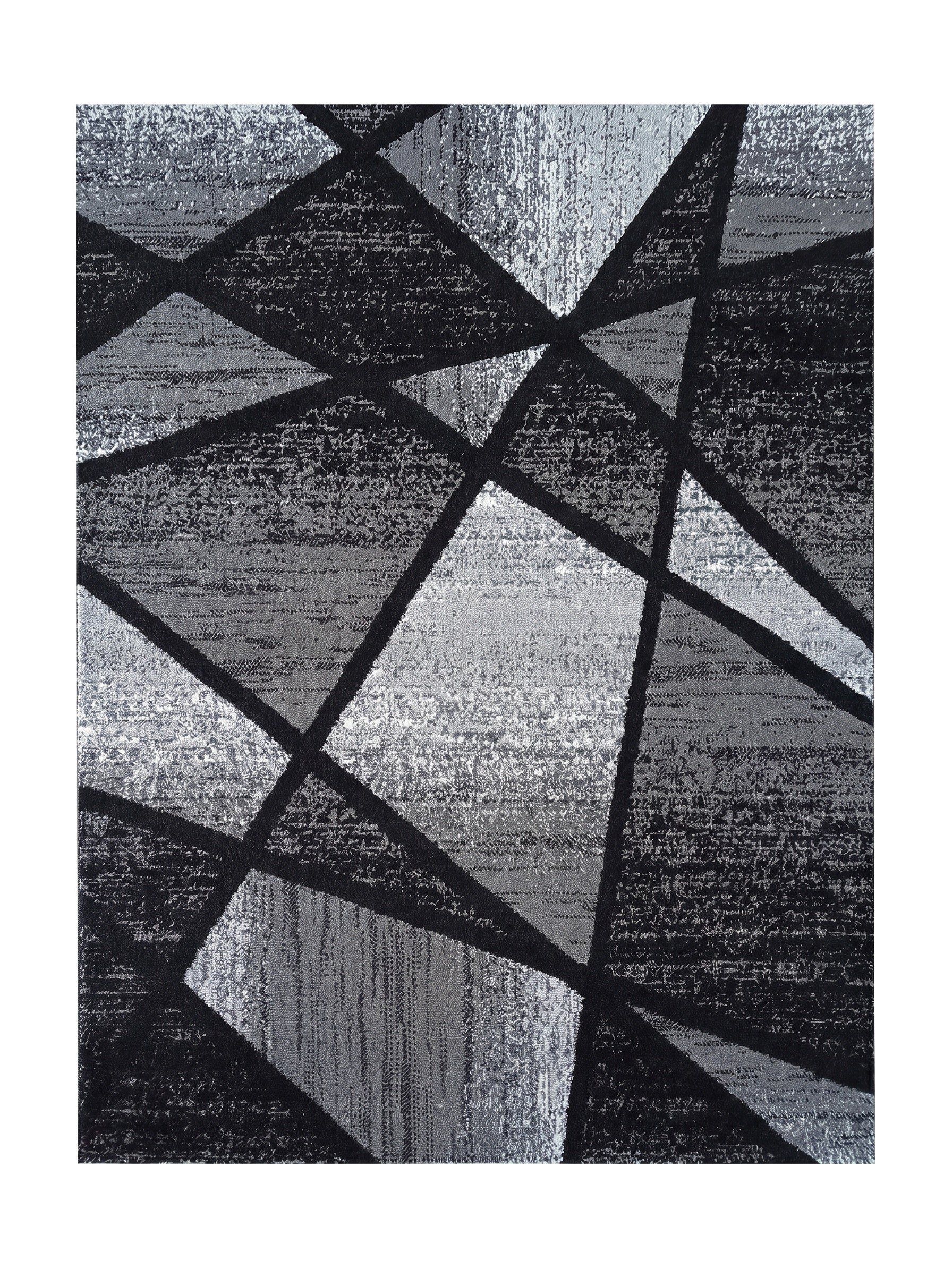 Tapis aux motifs géométriques abstraits noirs et gris, avec des zones de textures variées et des dégradés de gris